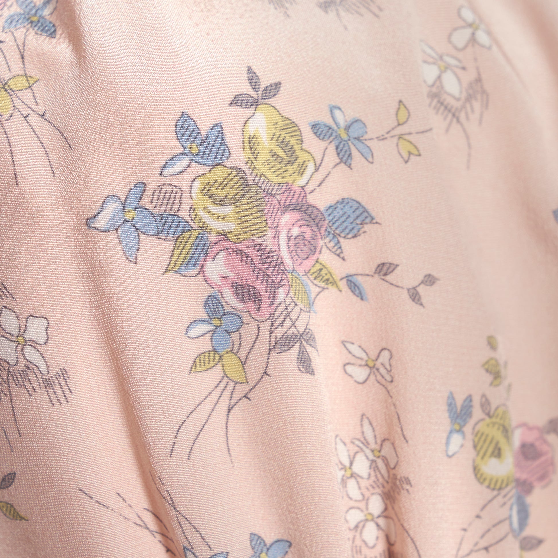 Light rose floral print silk crêpe de chine midi dress with long sleeves and open back, featuring ruffled cuffs and bows.