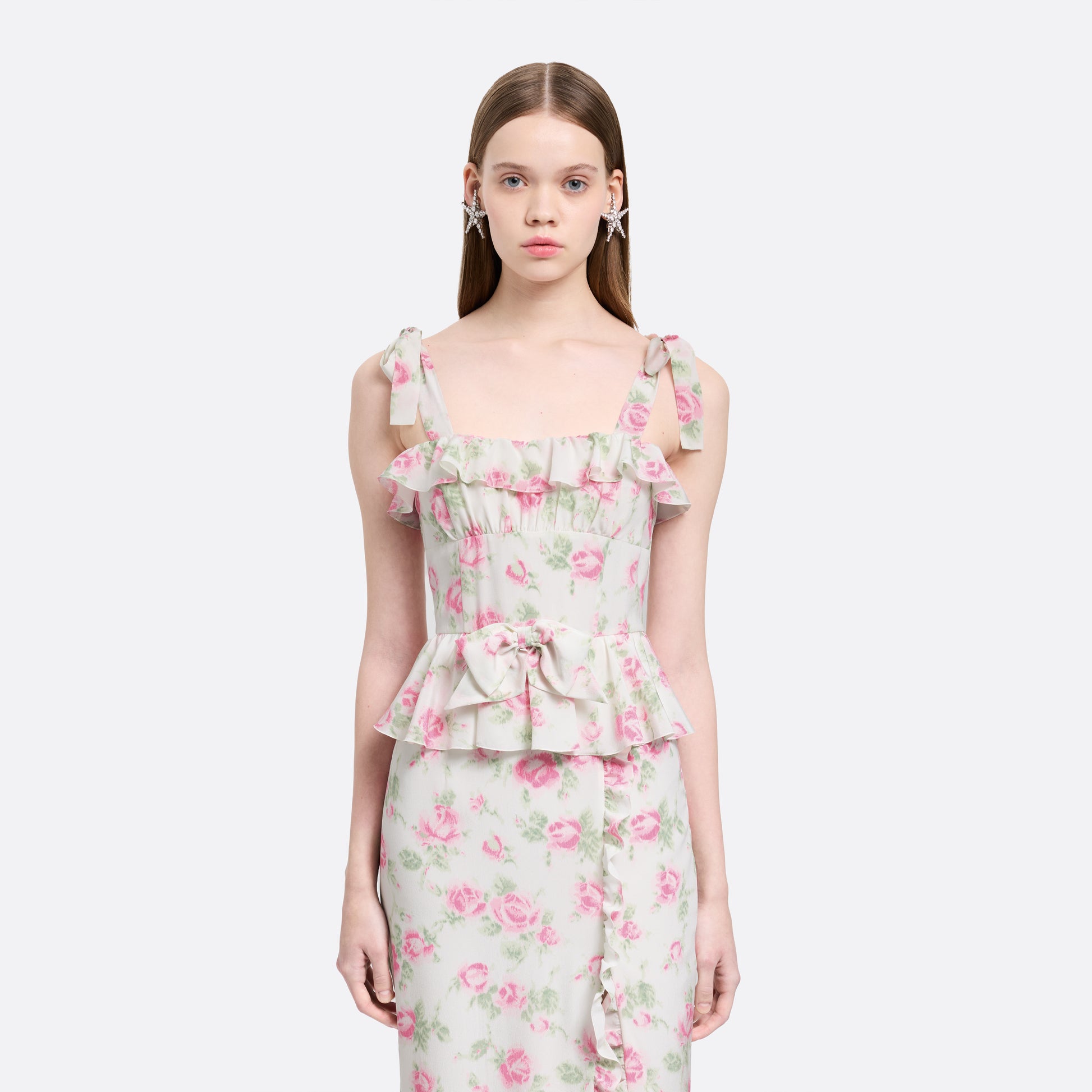 Pink and white floral-print silk crêpe de chine midi dress with self-tie shoulder straps and a ruffled neckline. A peplum defines the silhouette, while the straight skirt is finished with delicate ruffle trim.