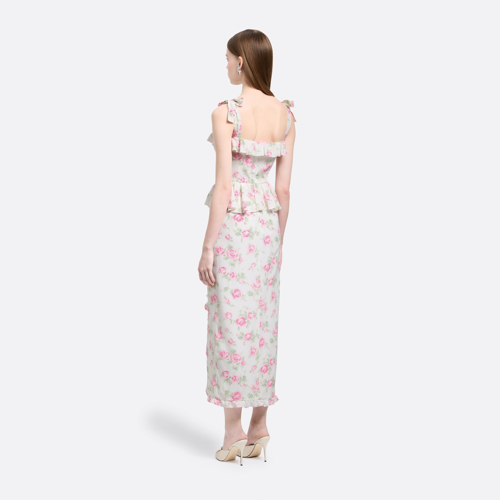 Pink and white floral-print silk crêpe de chine midi dress with self-tie shoulder straps and a ruffled neckline. A peplum defines the silhouette, while the straight skirt is finished with delicate ruffle trim.