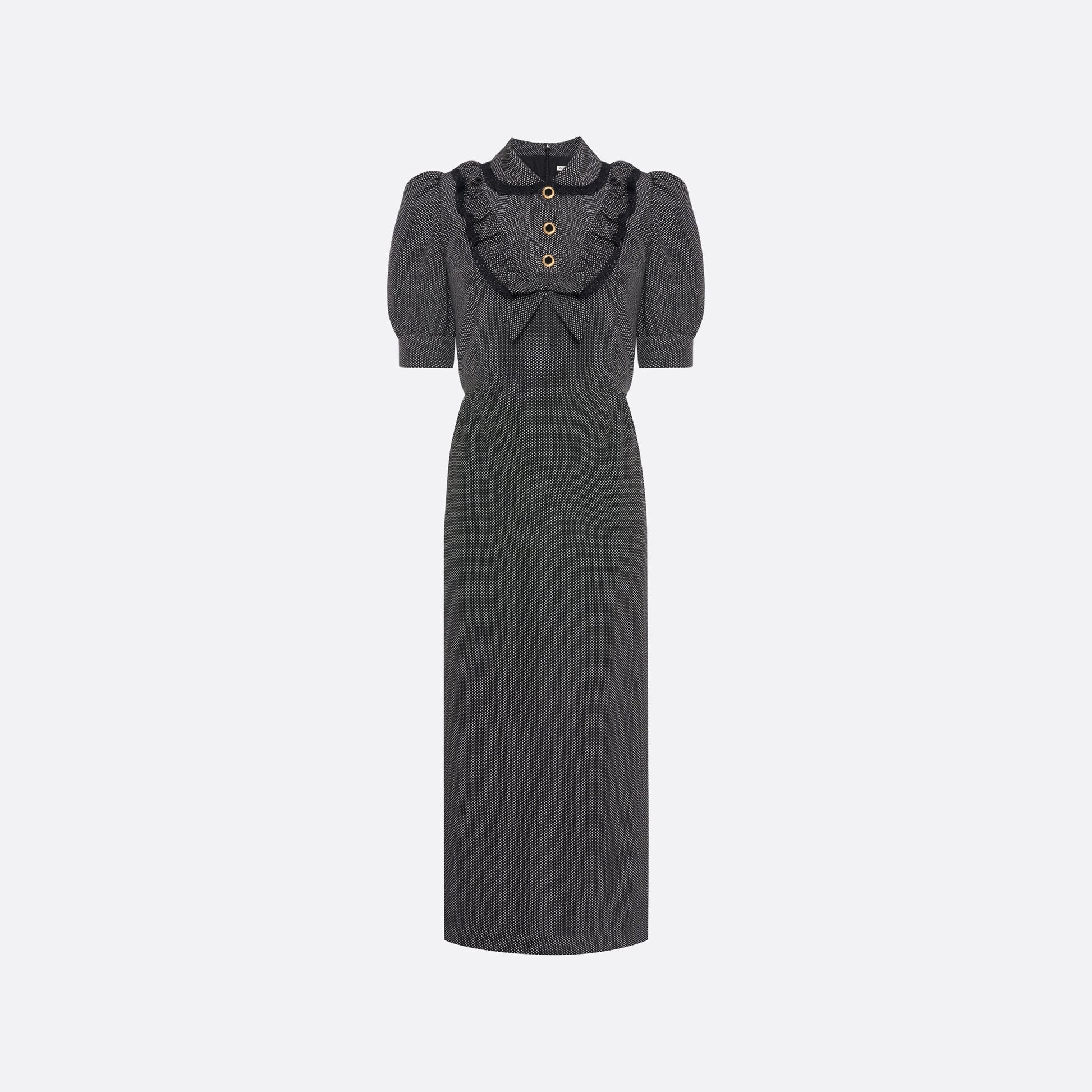 Black and white small polka-dot print silk crêpe de chine midi dress with short puffed sleeeves and black and old tone buttons. Finished with a lace trimmed collar and ruffled bib detailing.

Look 31 – Fall Winter 2026 Lookbook.