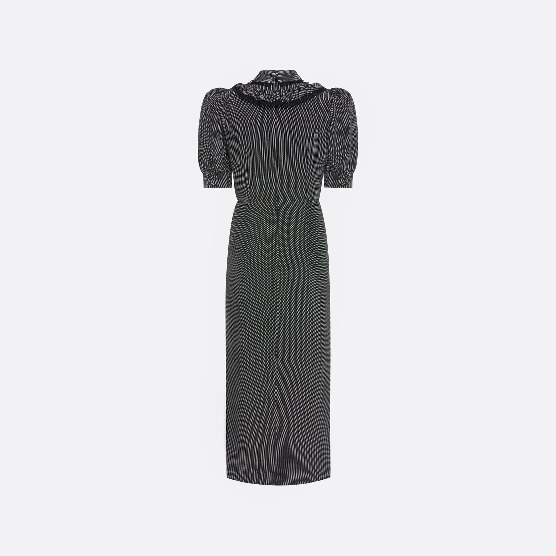 Black and white small polka-dot print silk crêpe de chine midi dress with short puffed sleeeves and black and old tone buttons. Finished with a lace trimmed collar and ruffled bib detailing.

Look 31 – Fall Winter 2026 Lookbook.
