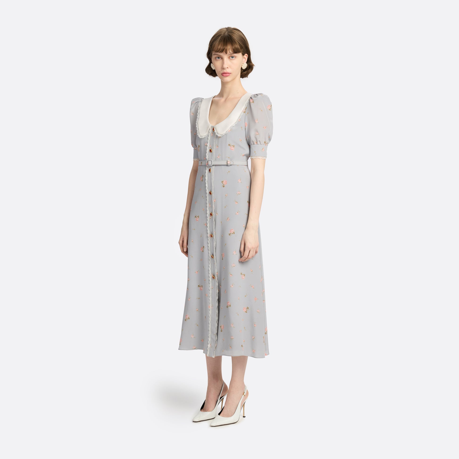 Pearl-grey and pink floral-print silk crêpe de chine midi dress with a front button closure, a rounded collar framed by lace trim and short puff sleeves. Finished with red and gold-tone buttons and a slim belt.