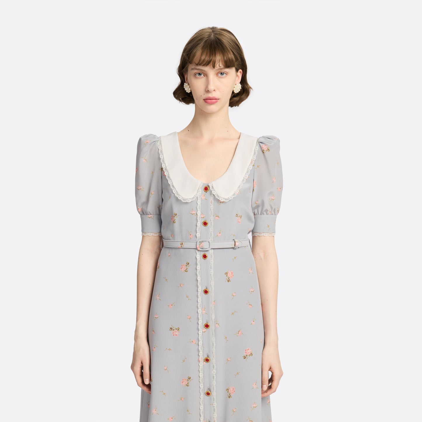 Pearl-grey and pink floral-print silk crêpe de chine midi dress with a front button closure, a rounded collar framed by lace trim and short puff sleeves. Finished with red and gold-tone buttons and a slim belt.