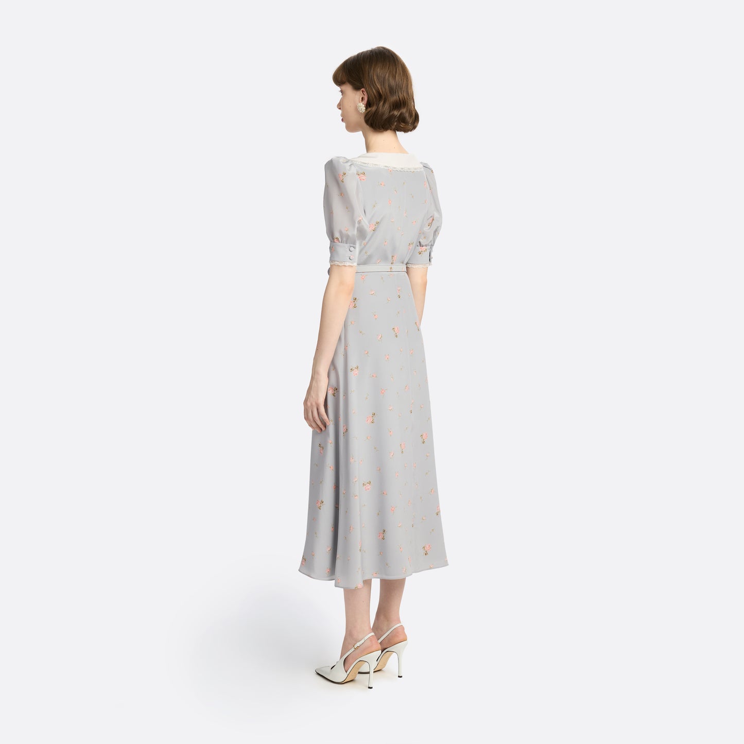 Pearl-grey and pink floral-print silk crêpe de chine midi dress with a front button closure, a rounded collar framed by lace trim and short puff sleeves. Finished with red and gold-tone buttons and a slim belt.