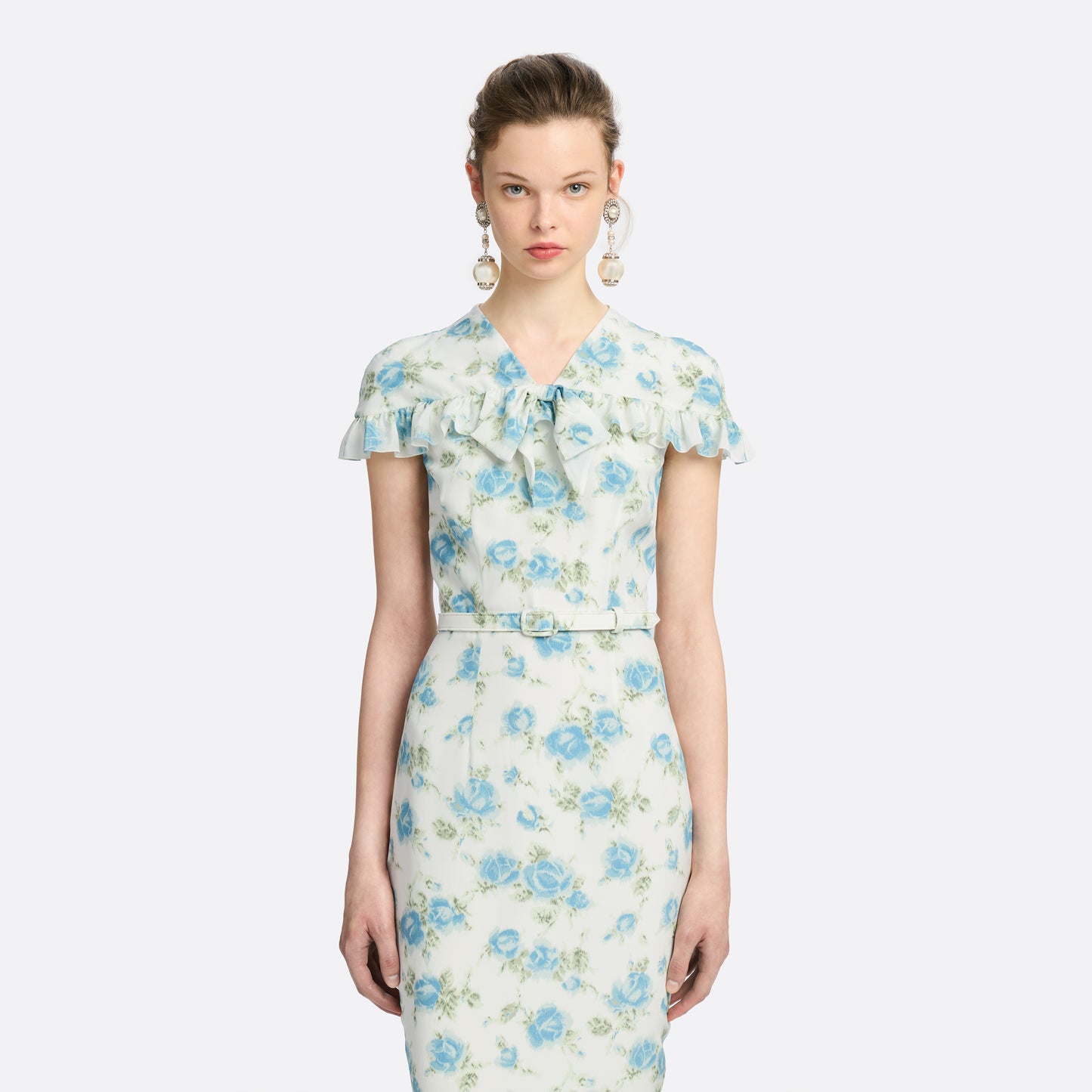 Light blue and white floral-print silk crêpe de chine midi dress with a high neckline and bow detail. With a fitted silhouette, it is finished with ruffle-trimmed short sleeves and a slim belt.

Look 14 – Fall Winter 2026 Lookbook.
