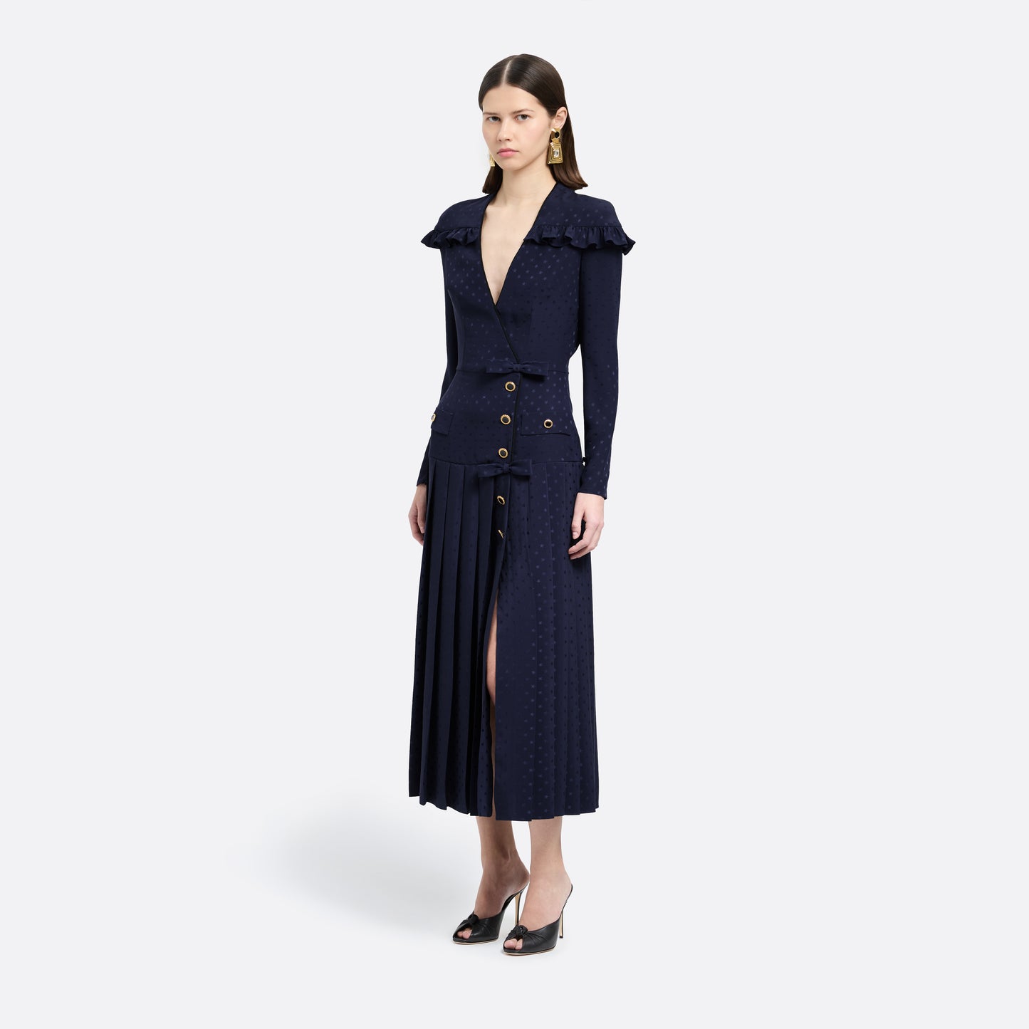 Navy blue star-jacquard silk midi dress with a wrap-effect V-neckline detailed with a ruffled trim and long sleeves. Finished with black and gold-tone buttons, bows at the waist and a pleated skirt with a front split.
