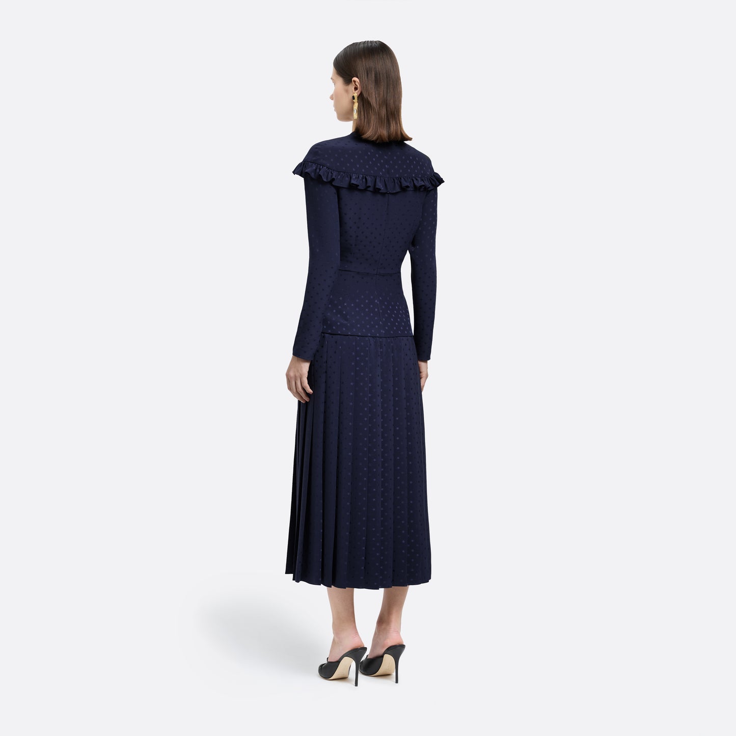 Navy blue star-jacquard silk midi dress with a wrap-effect V-neckline detailed with a ruffled trim and long sleeves. Finished with black and gold-tone buttons, bows at the waist and a pleated skirt with a front split.