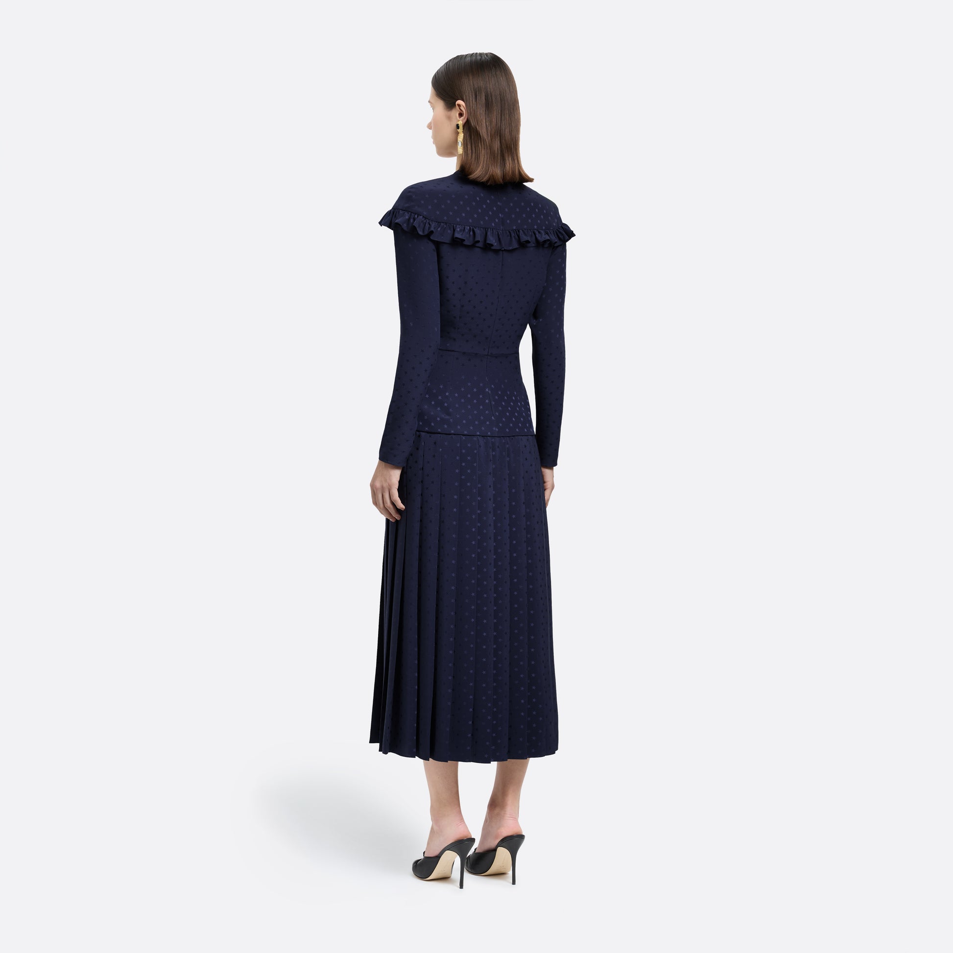 Navy blue star-jacquard silk midi dress with a wrap-effect V-neckline detailed with a ruffled trim and long sleeves. Finished with black and gold-tone buttons, bows at the waist and a pleated skirt with a front split.