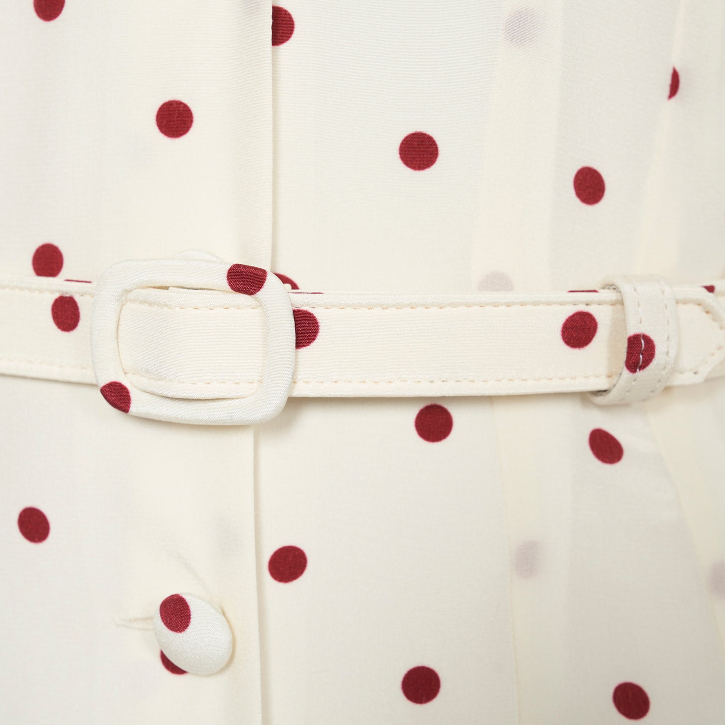 Cream and bordeaux polka-dot silk crêpe de chine midi dress with a deep V-neckline framed by a ruffle-trimmed collar, a front button closure, long sleeves and a slim belt.