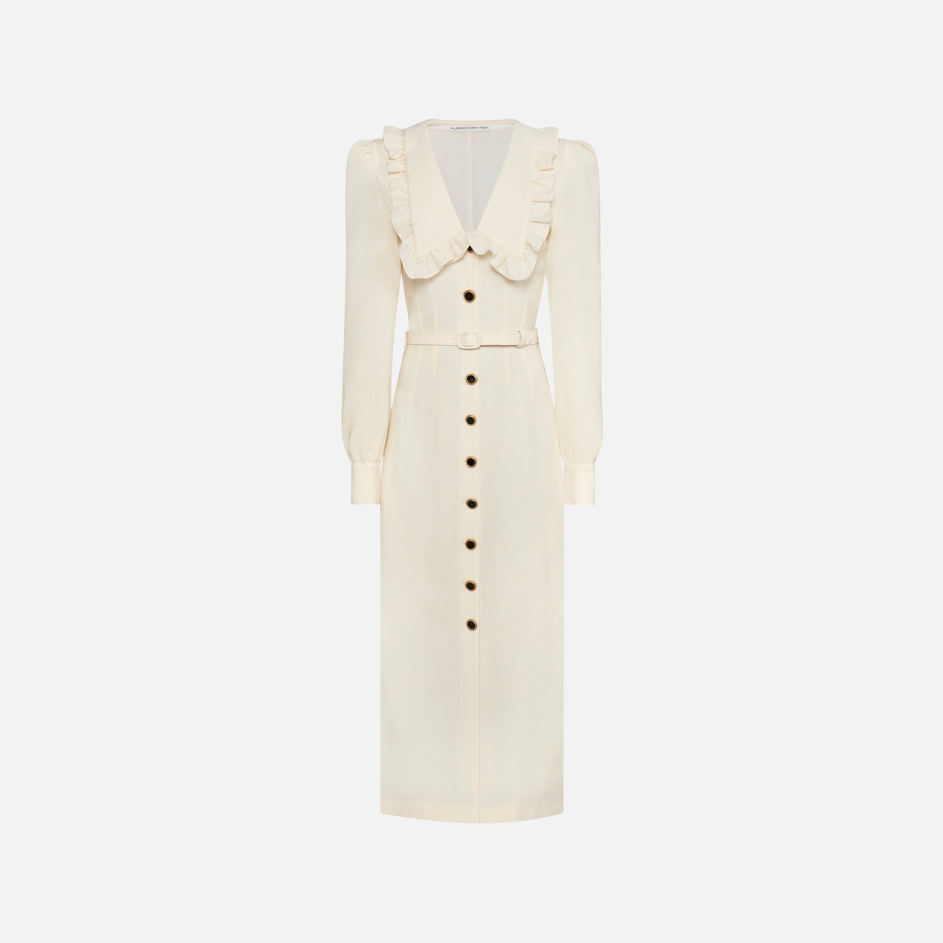 Cream light wool crêpe midi dress with a deep V-neckline framed by a ruffle-trimmed collar and long sleeves. Finished with a front button closure accented by black and gold-tone buttons and a slim belt.

Look 10 – Fall Winter 2026 Lookbook.