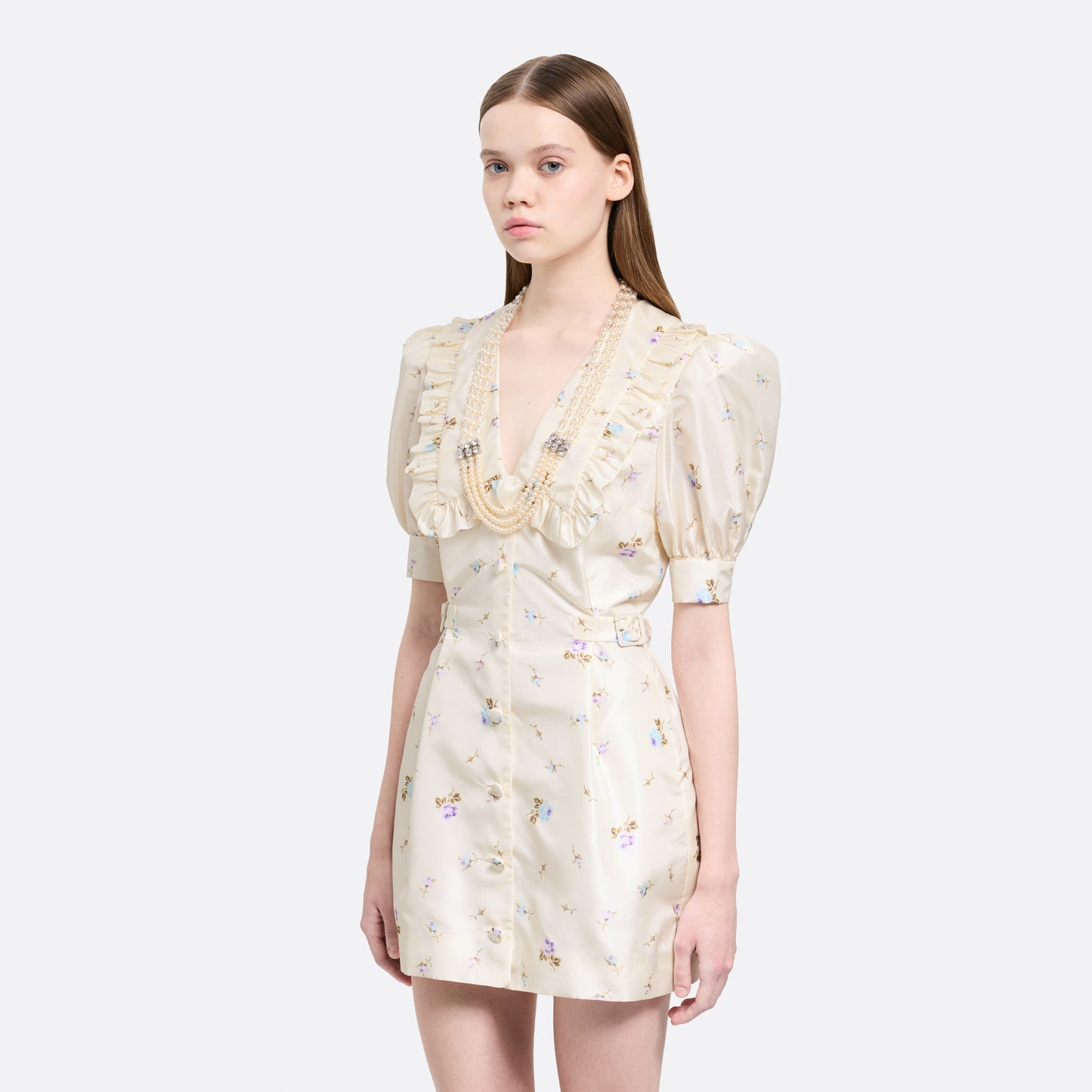 Floral-print white silk taffeta mini dress with a front button closure, ruffled collar and puff sleeves. Finished with side buckles and pockets.