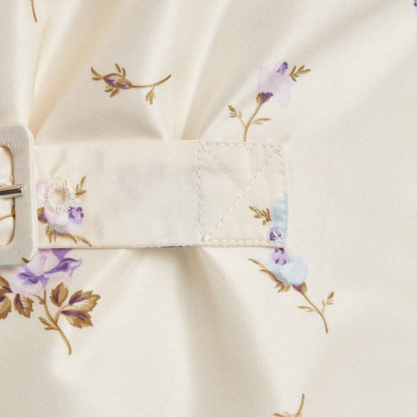 Floral-print white silk taffeta mini dress with a front button closure, ruffled collar and puff sleeves. Finished with side buckles and pockets.
