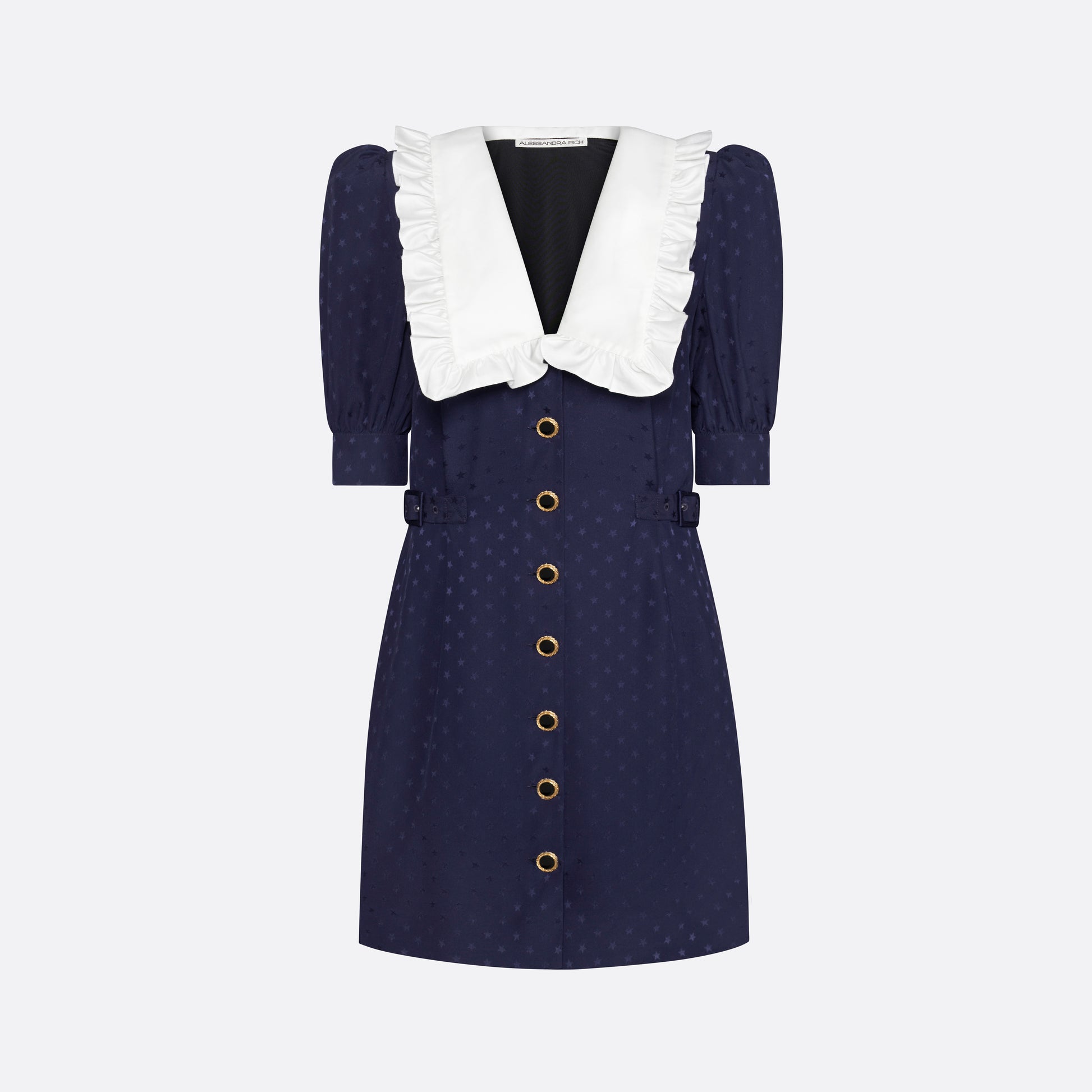Navy blue star-jacquard silk mini dress with a front button closure, contrasting ruffled collar and puff sleeves. Finished black and gold-tone buttons, side buckles and pockets.

Look 15 – Fall Winter 2026 Lookbook.