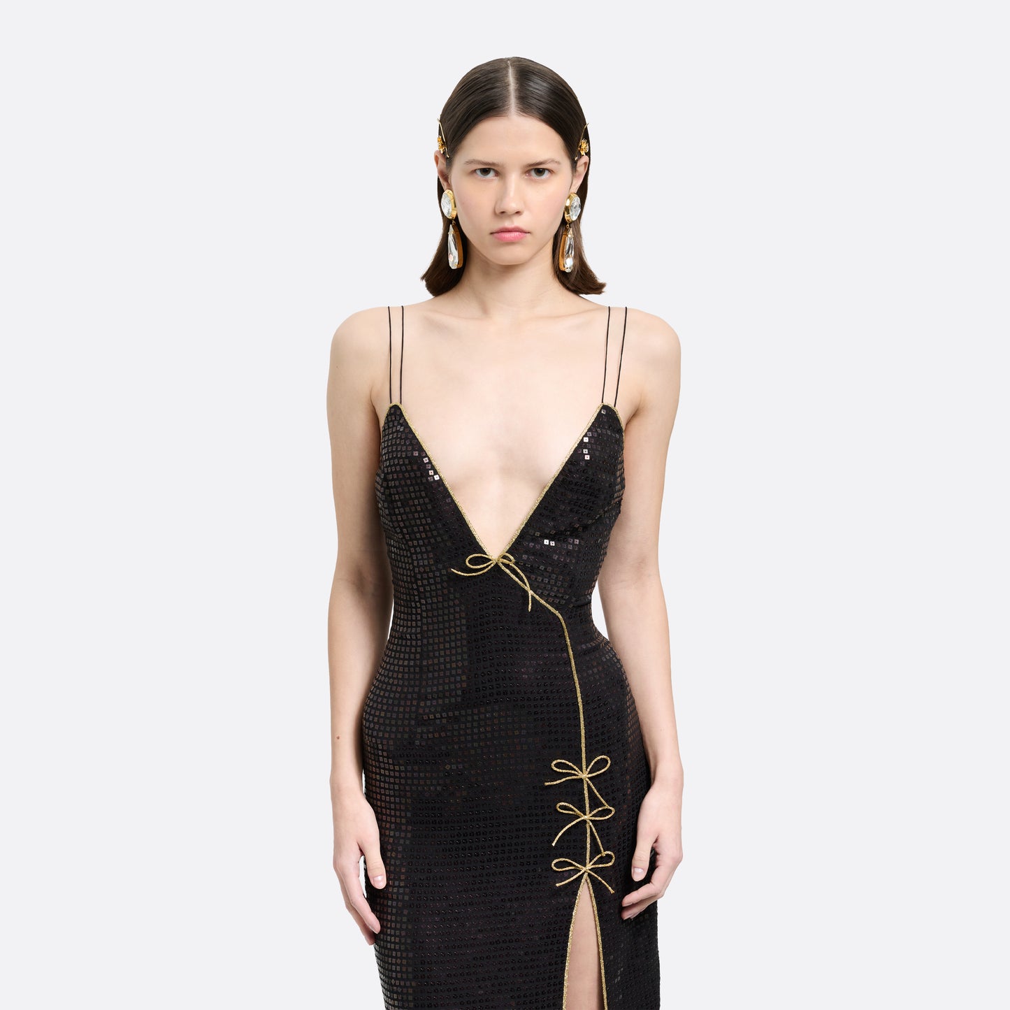 Black sequin-embroidered stretch silk georgette sleeveless dress cut to a fitted silhouette with a v-neckline. Finished with gold-tone bow details and side split.

Look 25 – Fall Winter 2026 Lookbook