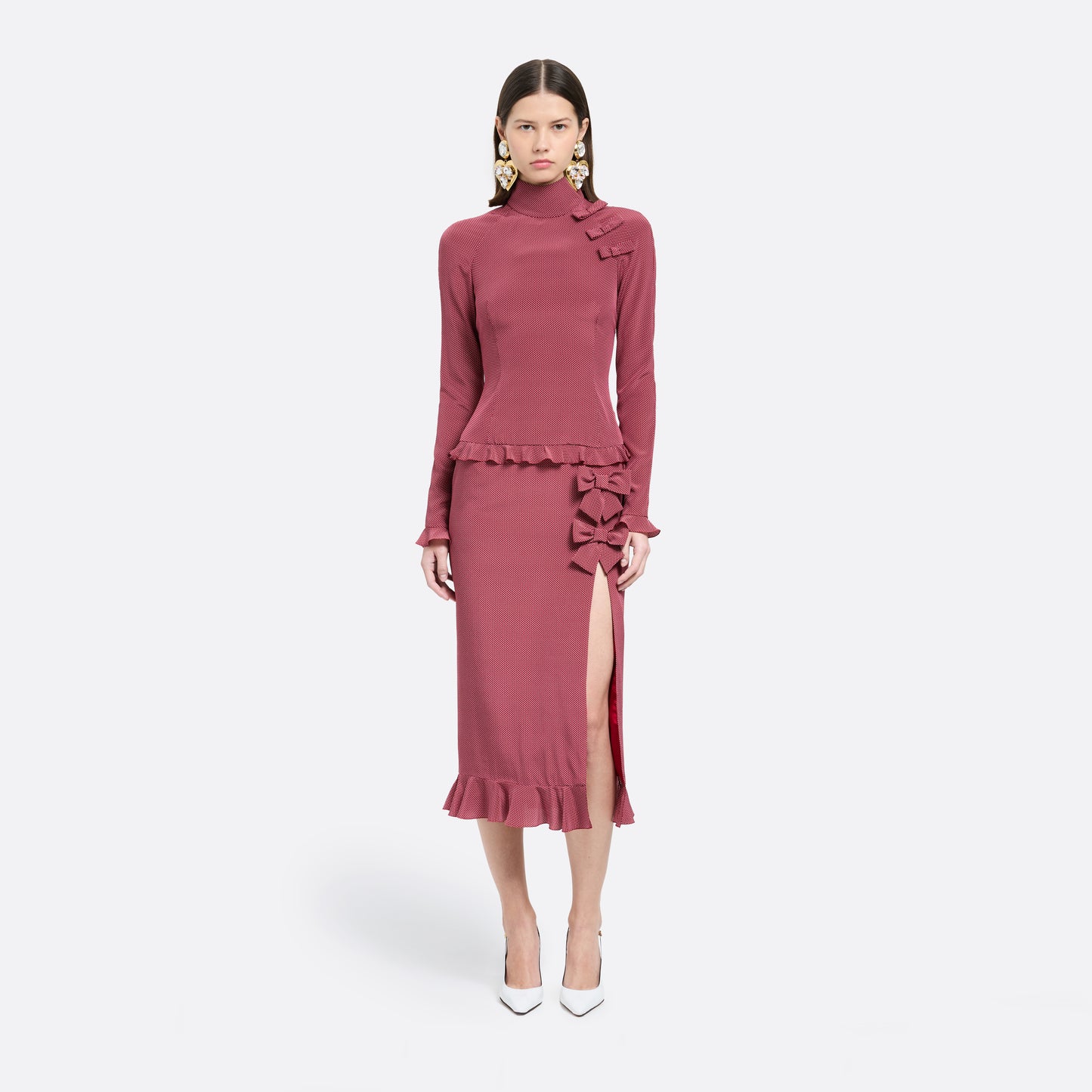 Bordeaux and white small polka-dot print silk crêpe de chine midi dress cut to a fitted silhouette with a high neckline and long sleeves. Finished with ruffled trims and bows.

Look 1 – Fall Winter 2026 Lookbook.