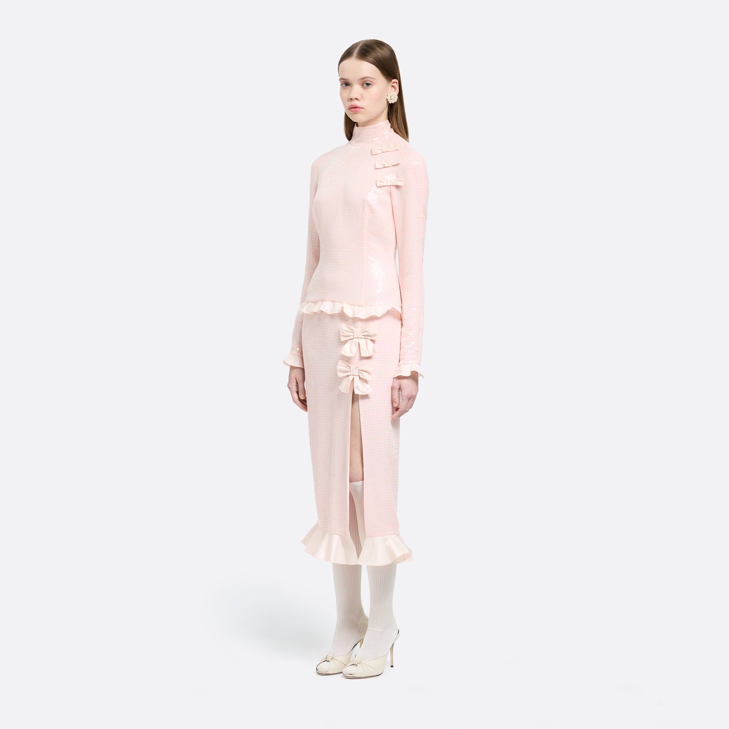Pink sequin-embroidered stretch silk georgette midi dress cut to a fitted silhouette with a high neckline and long sleeves. Finished with ruffled trims and bows.

Look 27 – Fall Winter 2026 Lookbook.