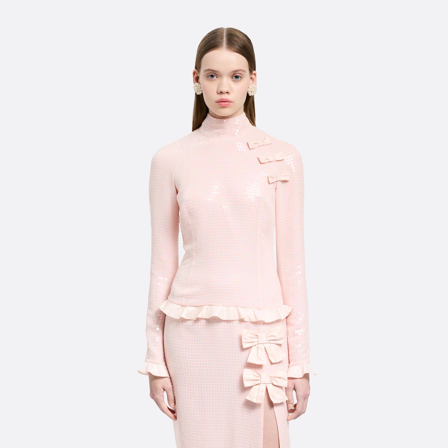 Pink sequin-embroidered stretch silk georgette midi dress cut to a fitted silhouette with a high neckline and long sleeves. Finished with ruffled trims and bows.

Look 27 – Fall Winter 2026 Lookbook.