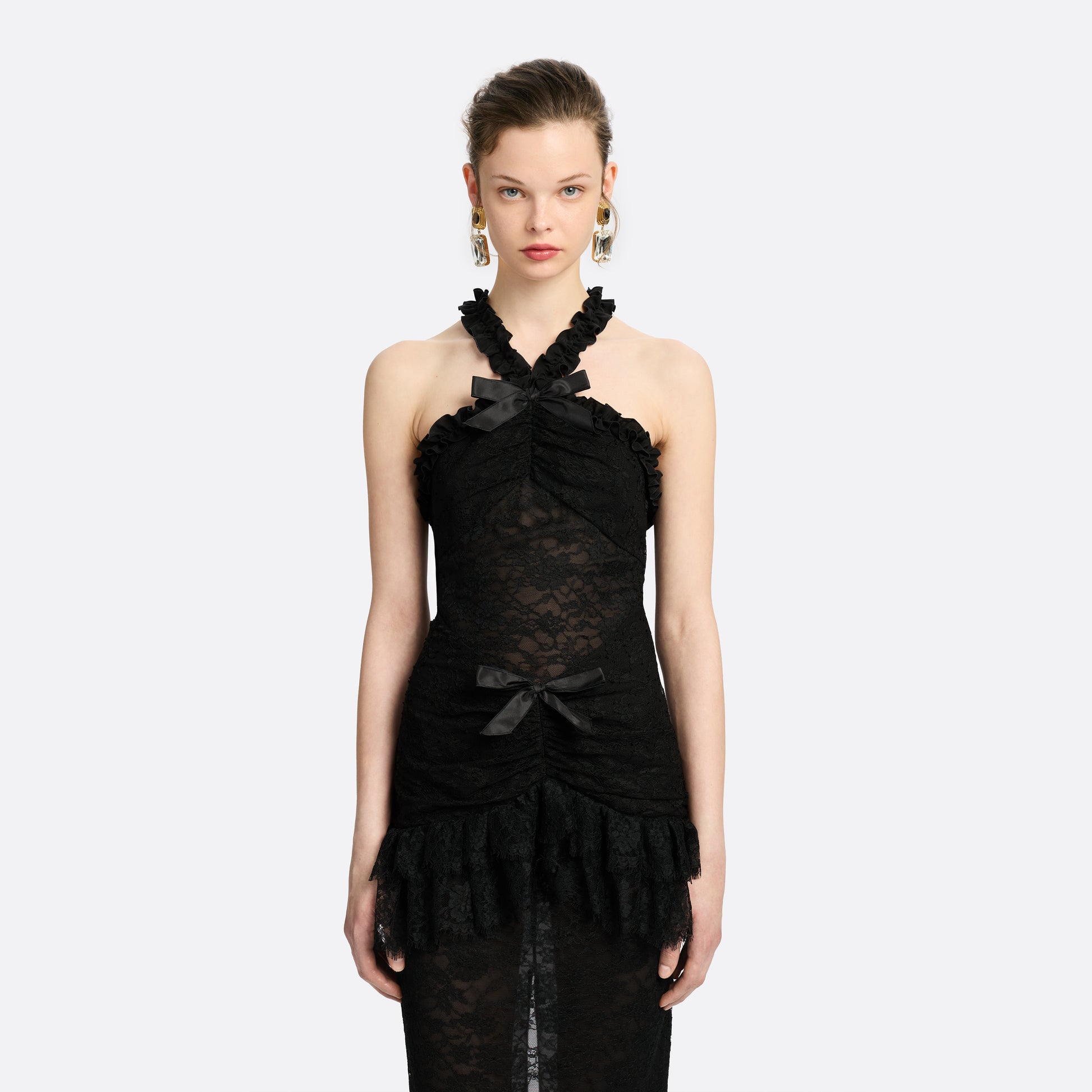 Black Chantilly lace halterneck evening dress with ruffled trims and bows.

Look 26 – Fall Winter 2026 Lookbook.