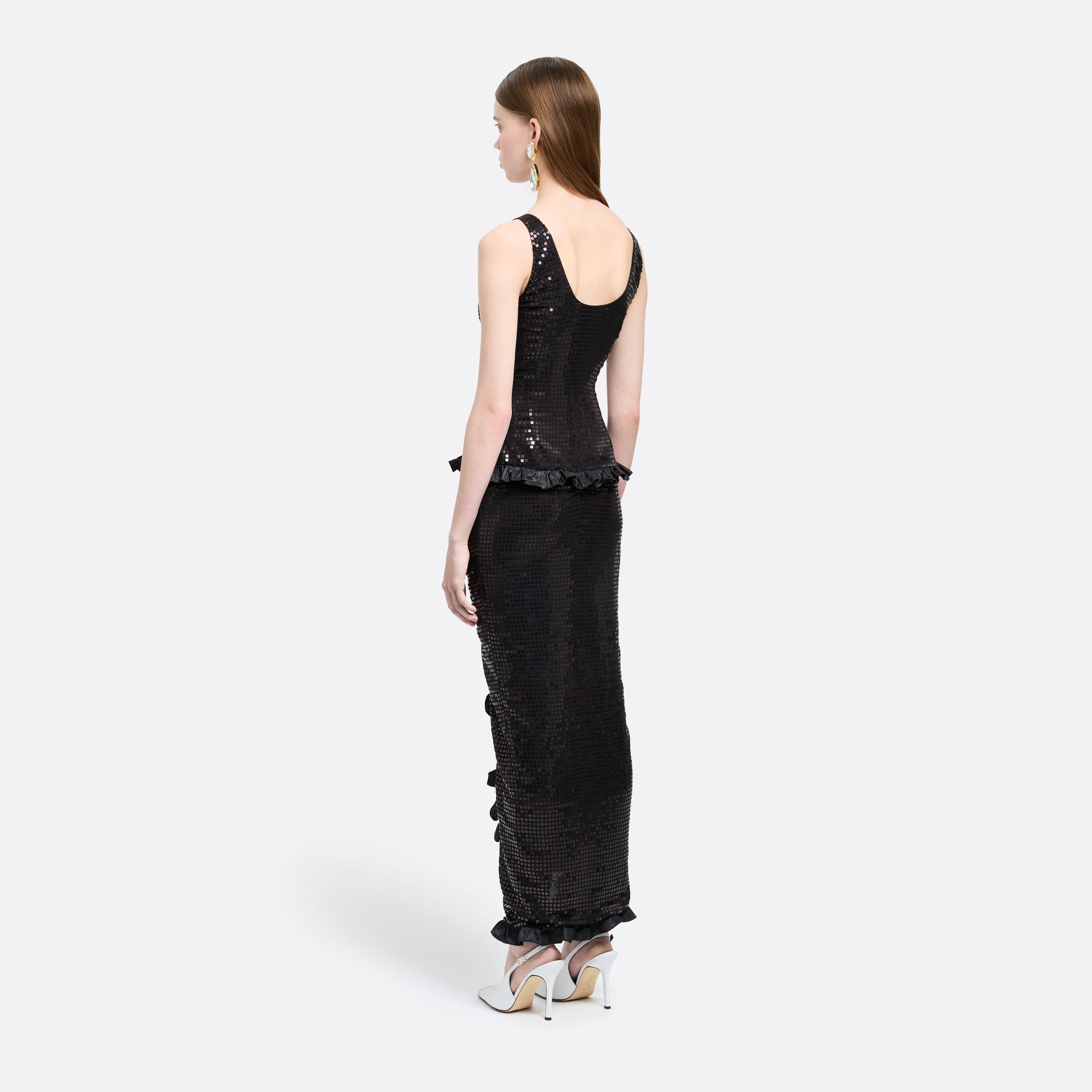 Black sequin-embroidered stretch silk georgette sleeveless dress cut to a fitted silhouette with a scoop neckline. Finished with ruffled trims at the waist and hem.

Look 25 – Fall Winter 2026 Lookbook.