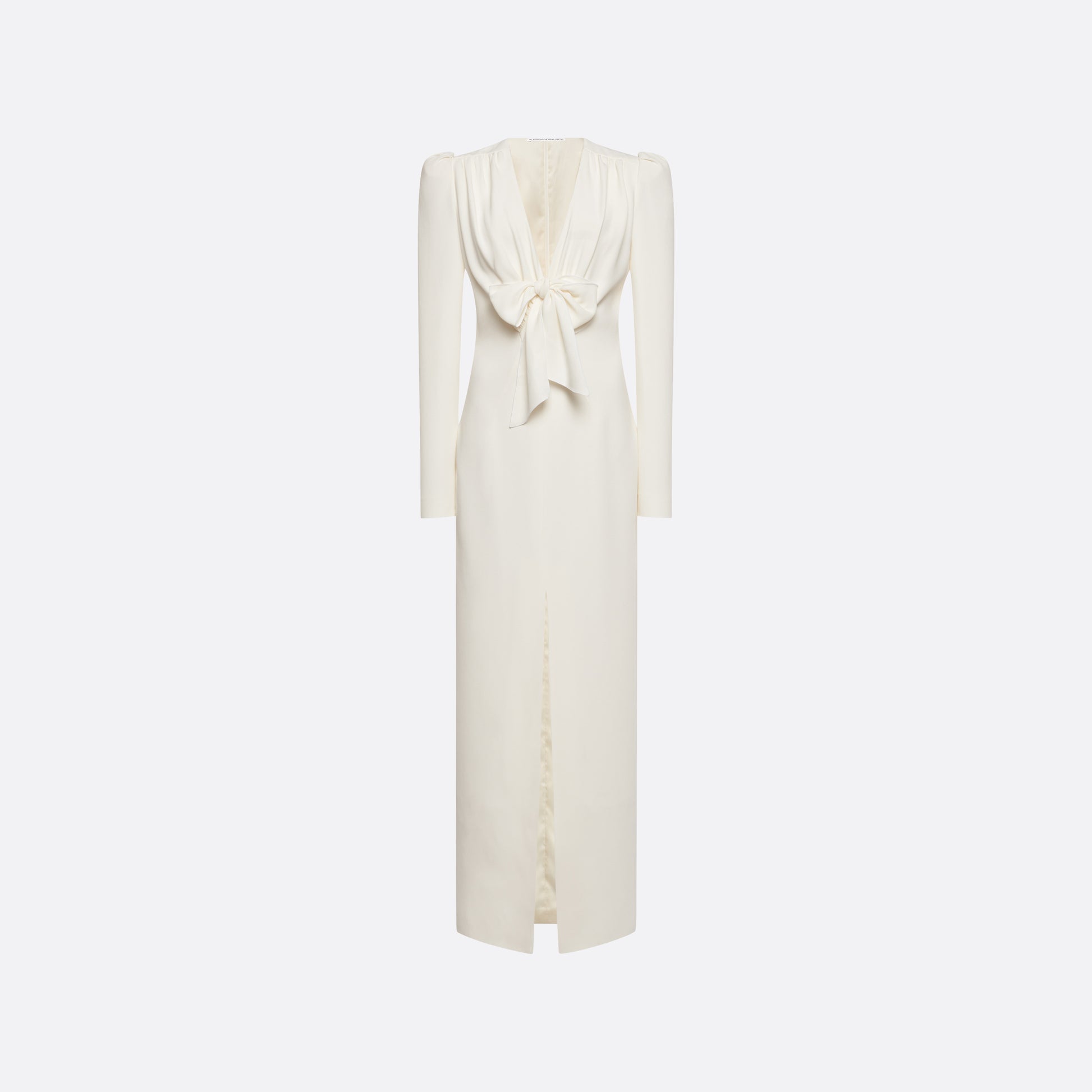 White cady evening dress cut to a fitted silhouette with a V-neckline and long sleeves. Finished with a bow detail and front split.