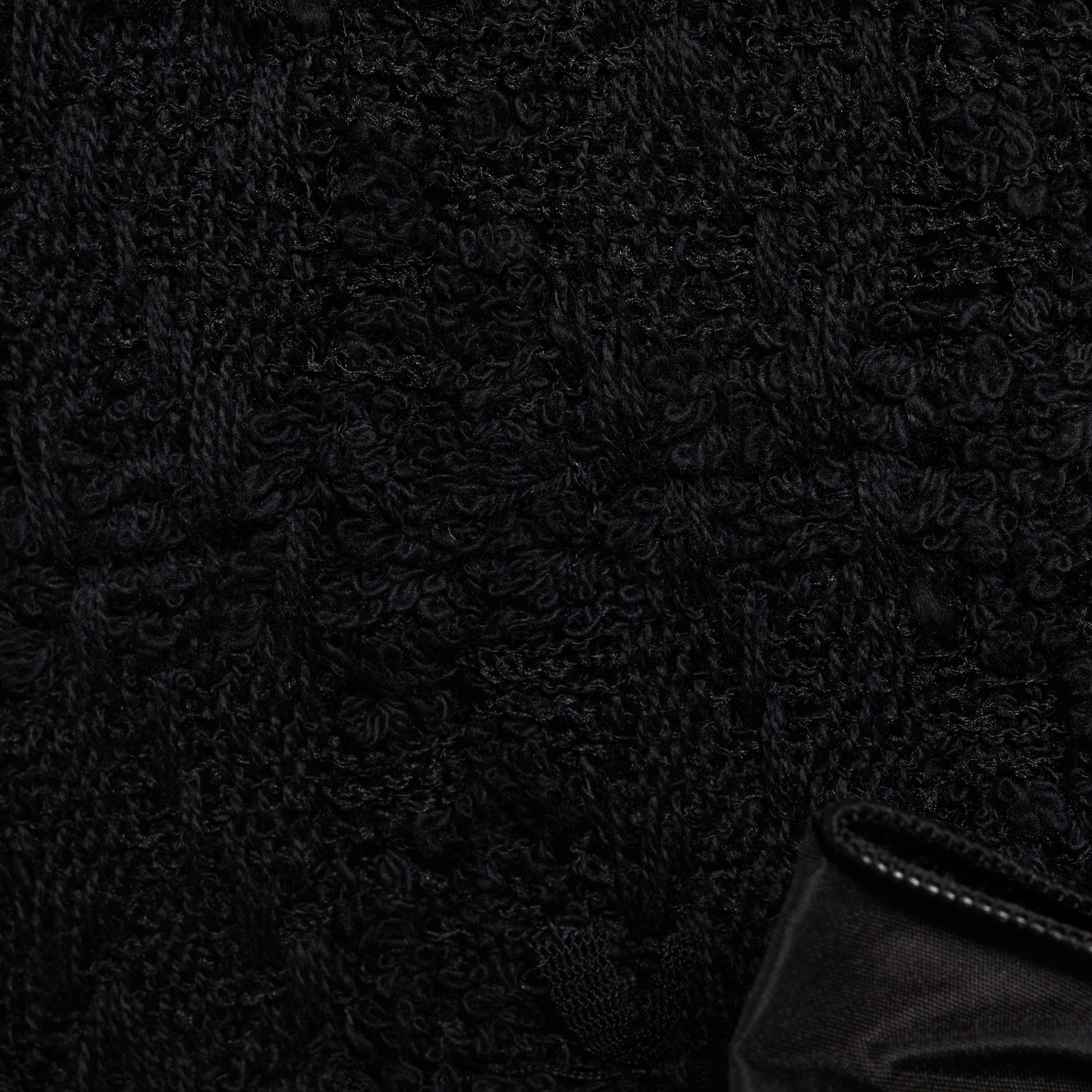 Black check tweed bouclé mini dress with a fitted silhouette and a soft ruffle at the hem. The shoulder straps are finished with bows.

Look 16 – Fall Winter 2026 Lookbook.