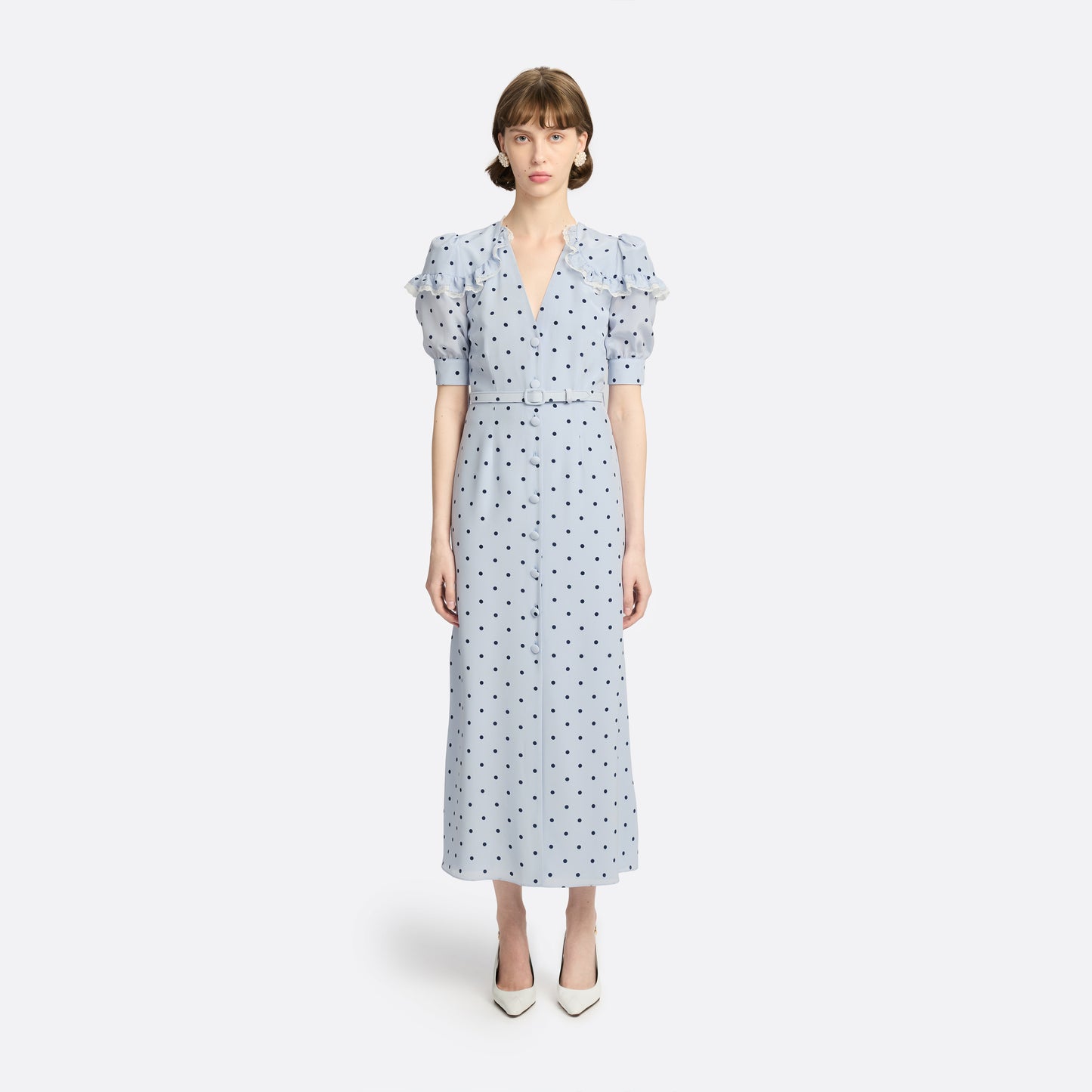 Light blue polka-dot silk midi dress with a V-neckline, front button closure and short puff sleeves detailed with lace-trimmed ruffles. Finished with a slim belt.