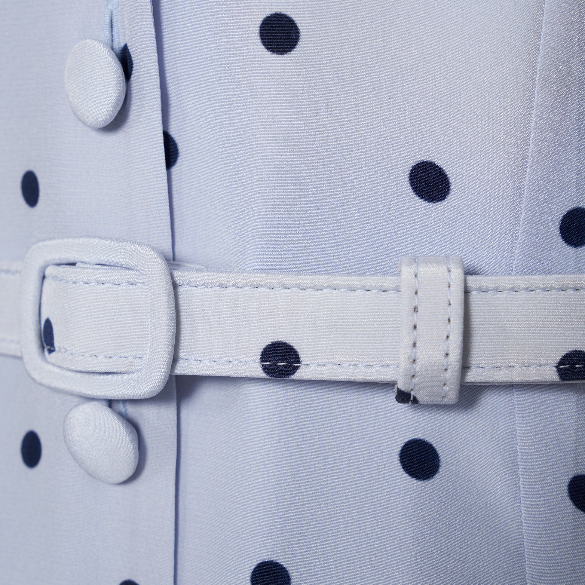 Light blue polka-dot silk midi dress with a V-neckline, front button closure and short puff sleeves detailed with lace-trimmed ruffles. Finished with a slim belt.
