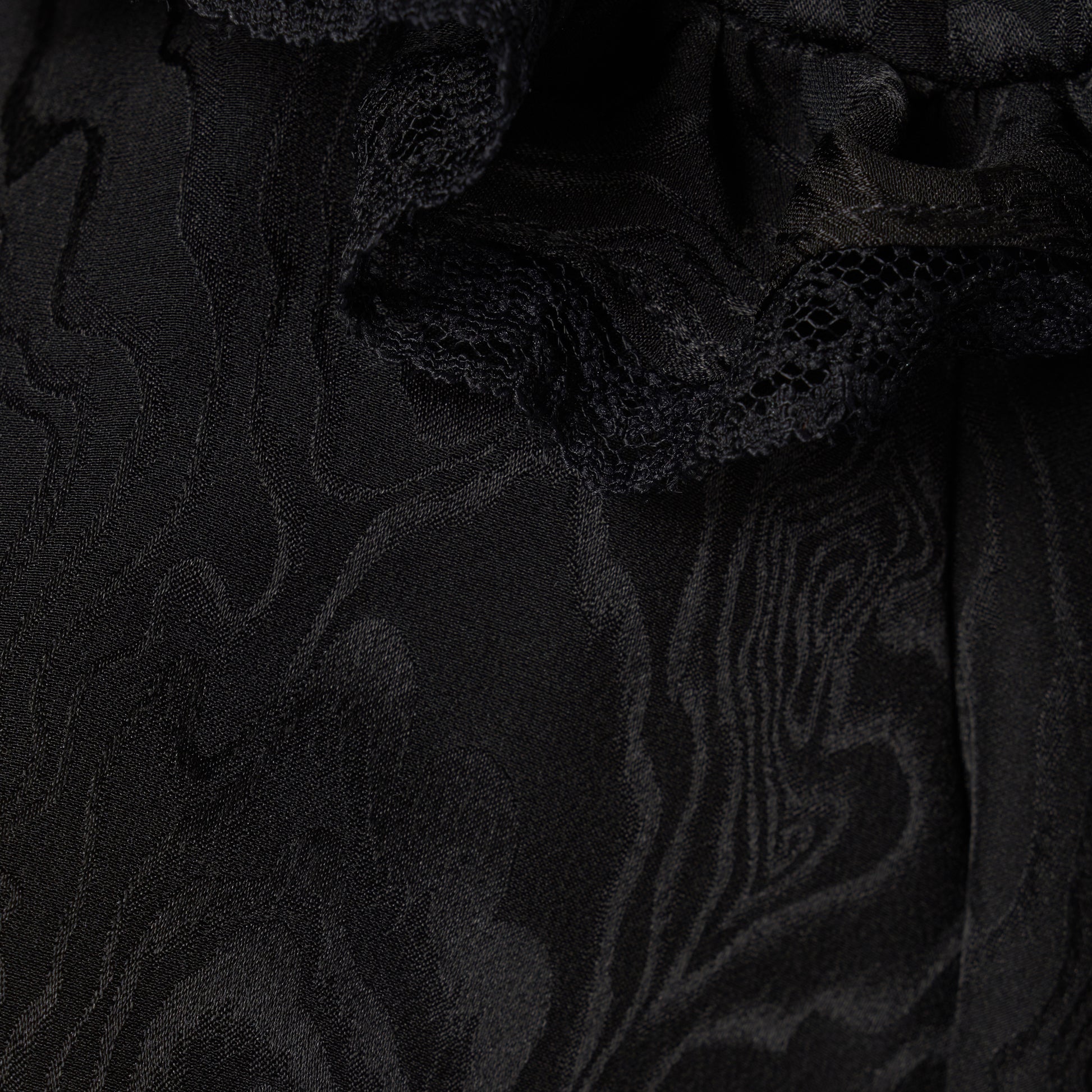 Black moiré silk jacquard midi dress with a V-neckline, front button closure and short puff sleeves detailed with lace-trimmed ruffles. Finished with jewel buttons and a slim belt.