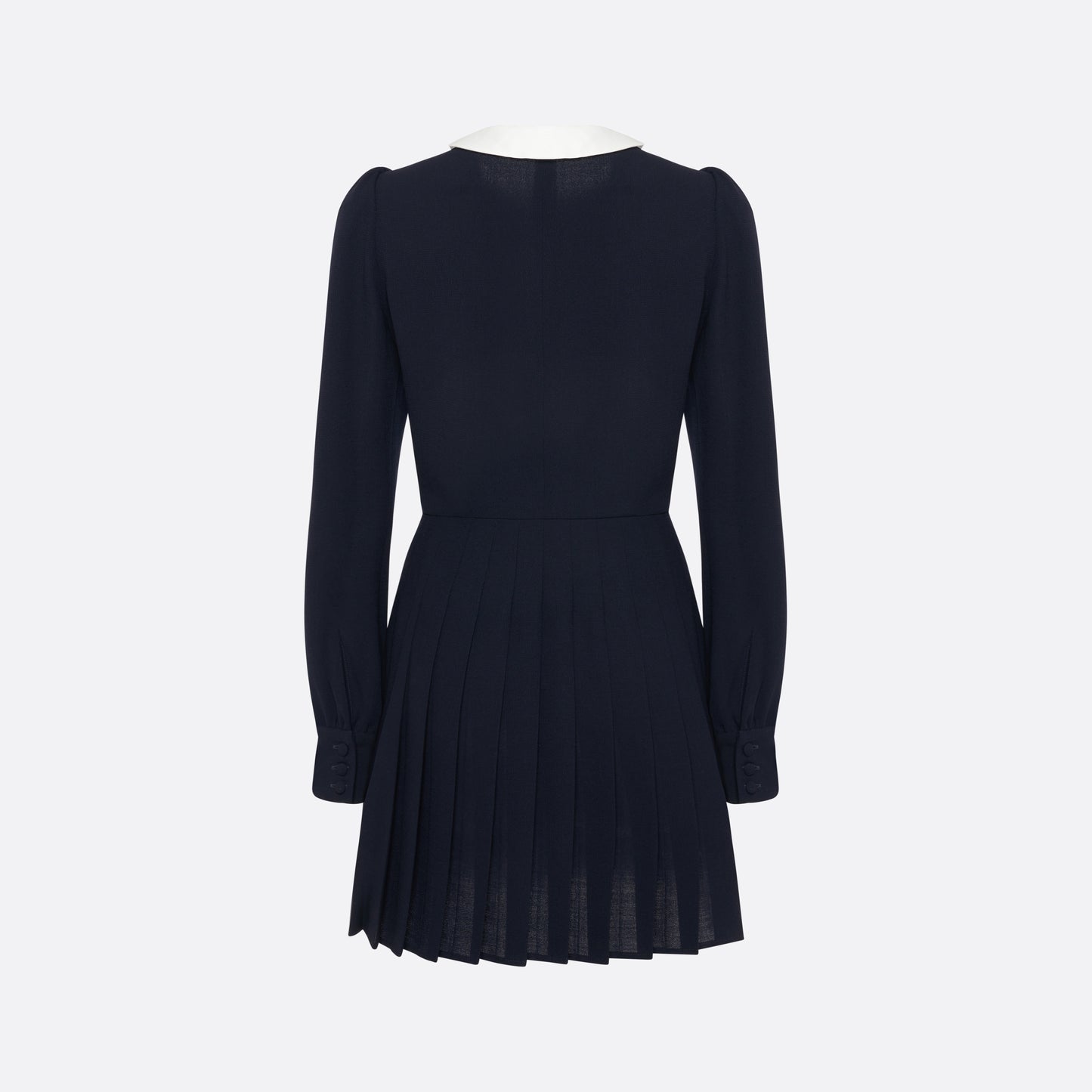 Navy blue light wool crêpe mini dress with a front button closure with black and gold tone buttons and a pleated skirt. Finished with a contrast collar and ruffle details.