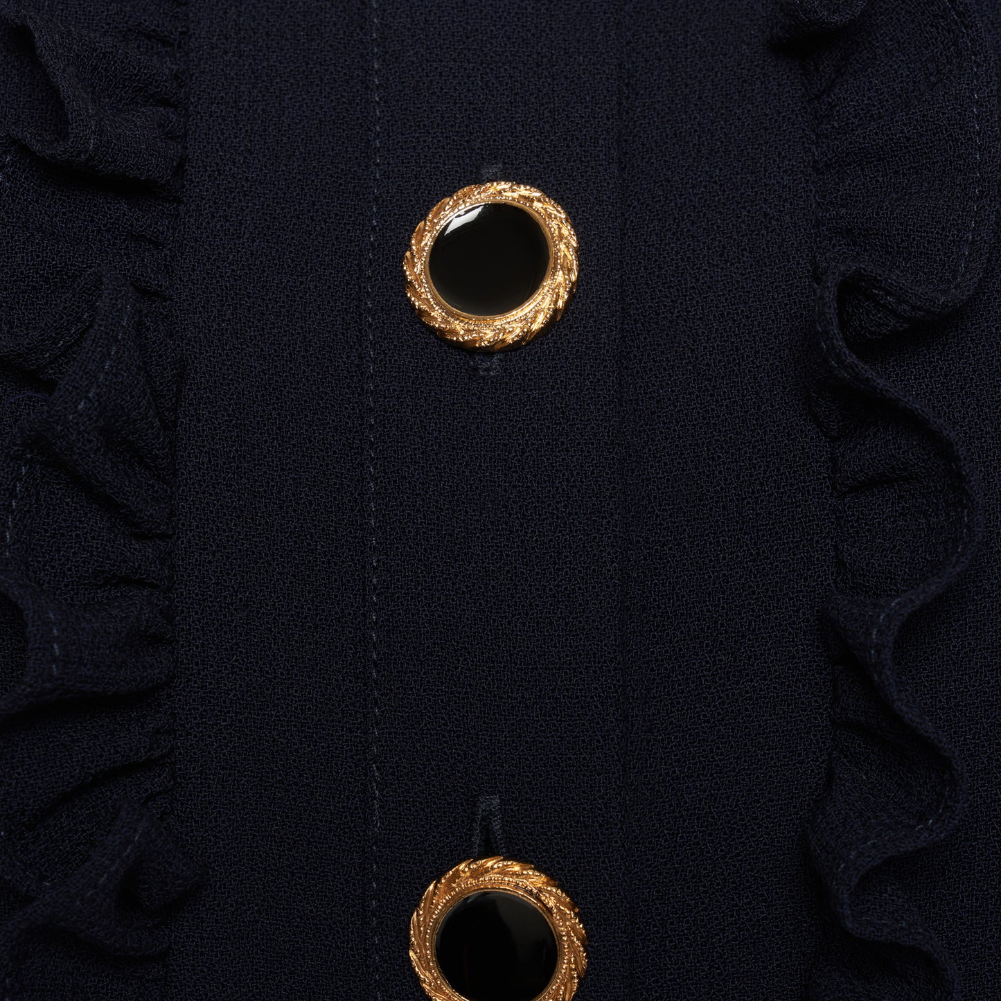 Navy blue light wool crêpe mini dress with a front button closure with black and gold tone buttons and a pleated skirt. Finished with a contrast collar and ruffle details.