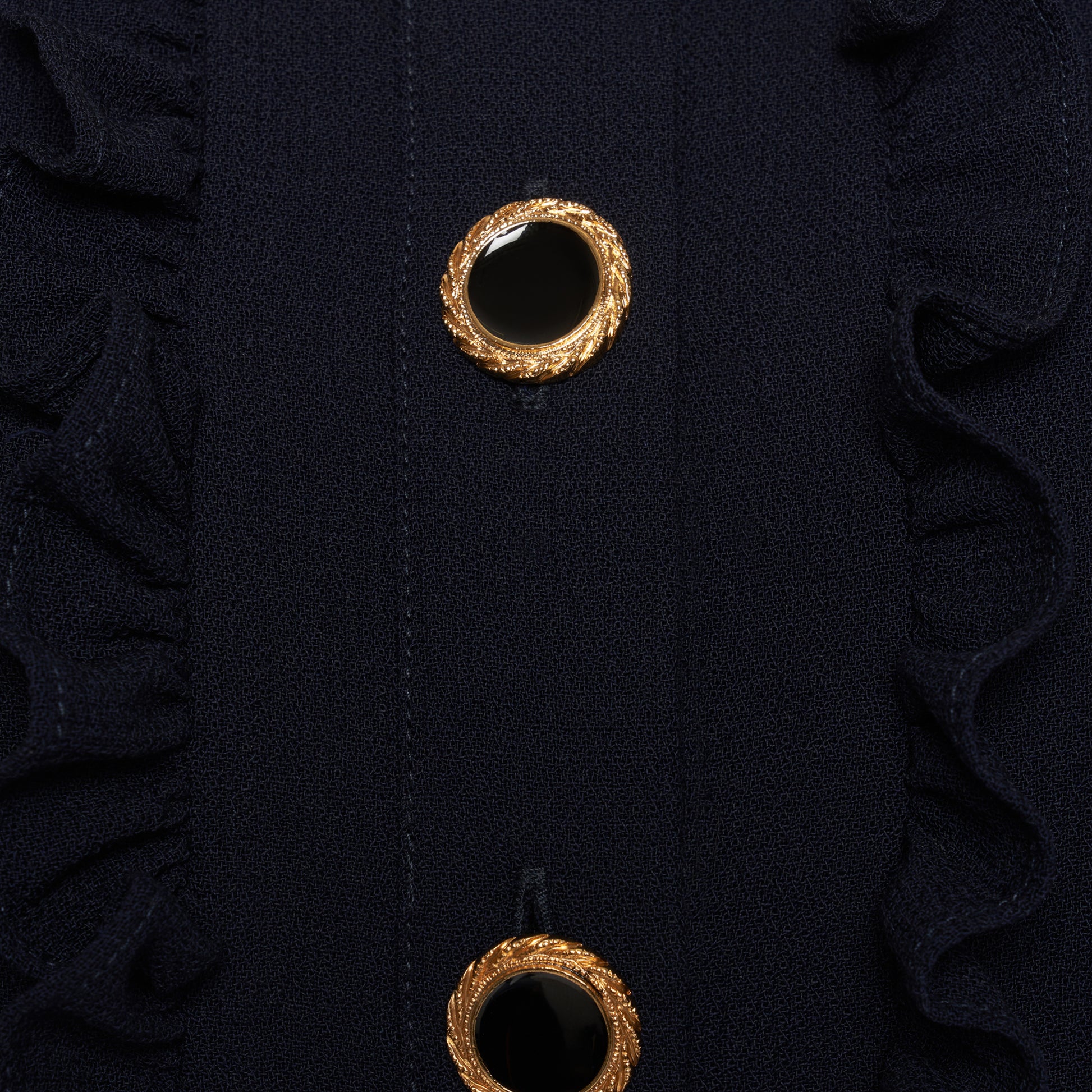 Navy blue light wool crêpe mini dress with a front button closure with black and gold tone buttons and a pleated skirt. Finished with a contrast collar and ruffle details.