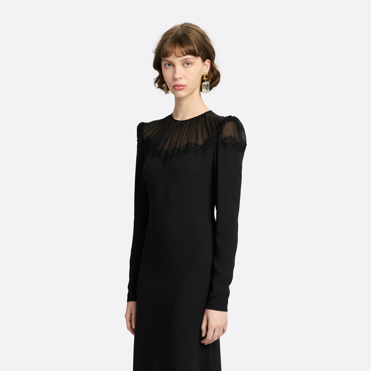 Black cady and silk georgette midi dress cut to a fitted silhouette with an A-line skirt. Finished with a sheer pleated yoke with delicate lace inlay.