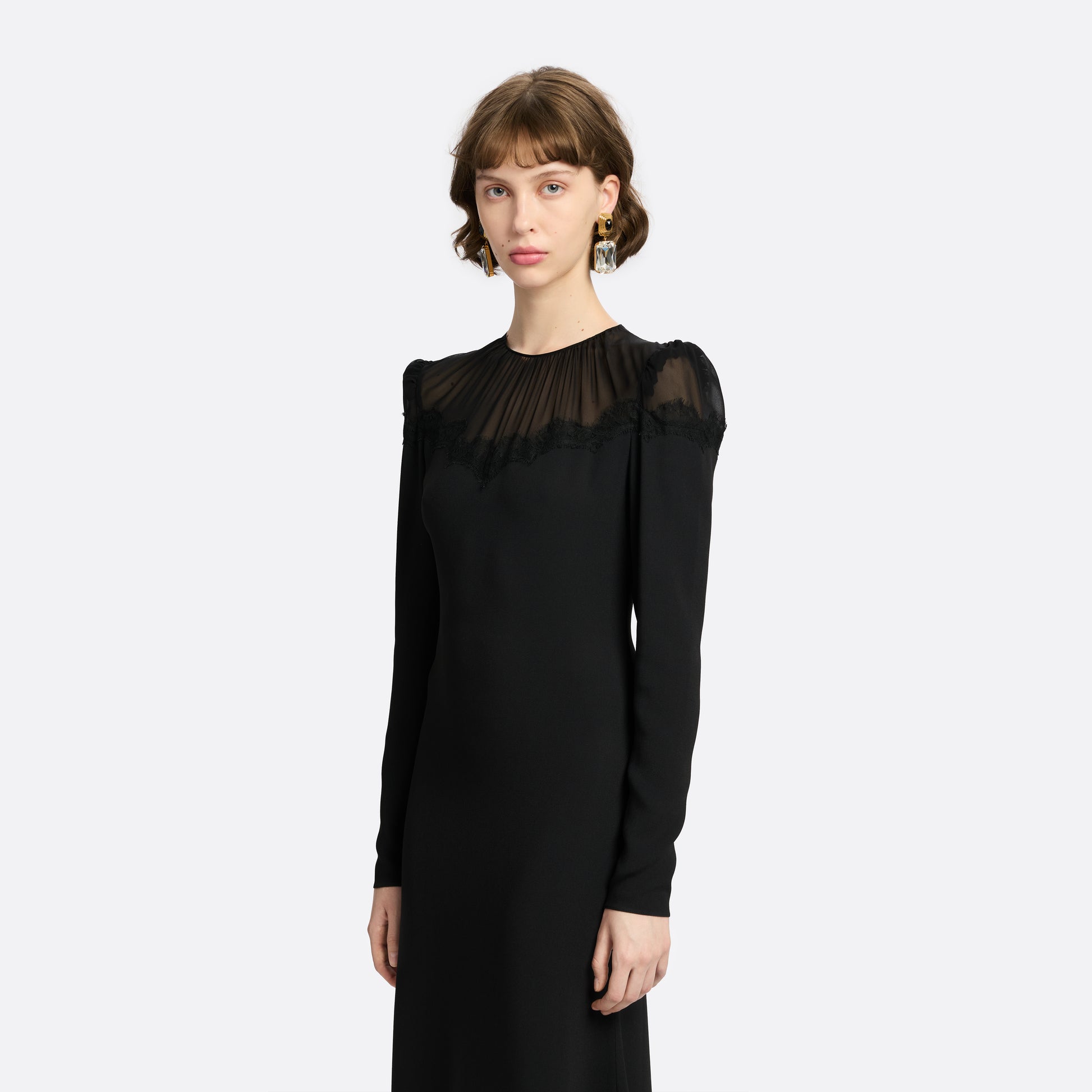 Black cady and silk georgette midi dress cut to a fitted silhouette with an A-line skirt. Finished with a sheer pleated yoke with delicate lace inlay.