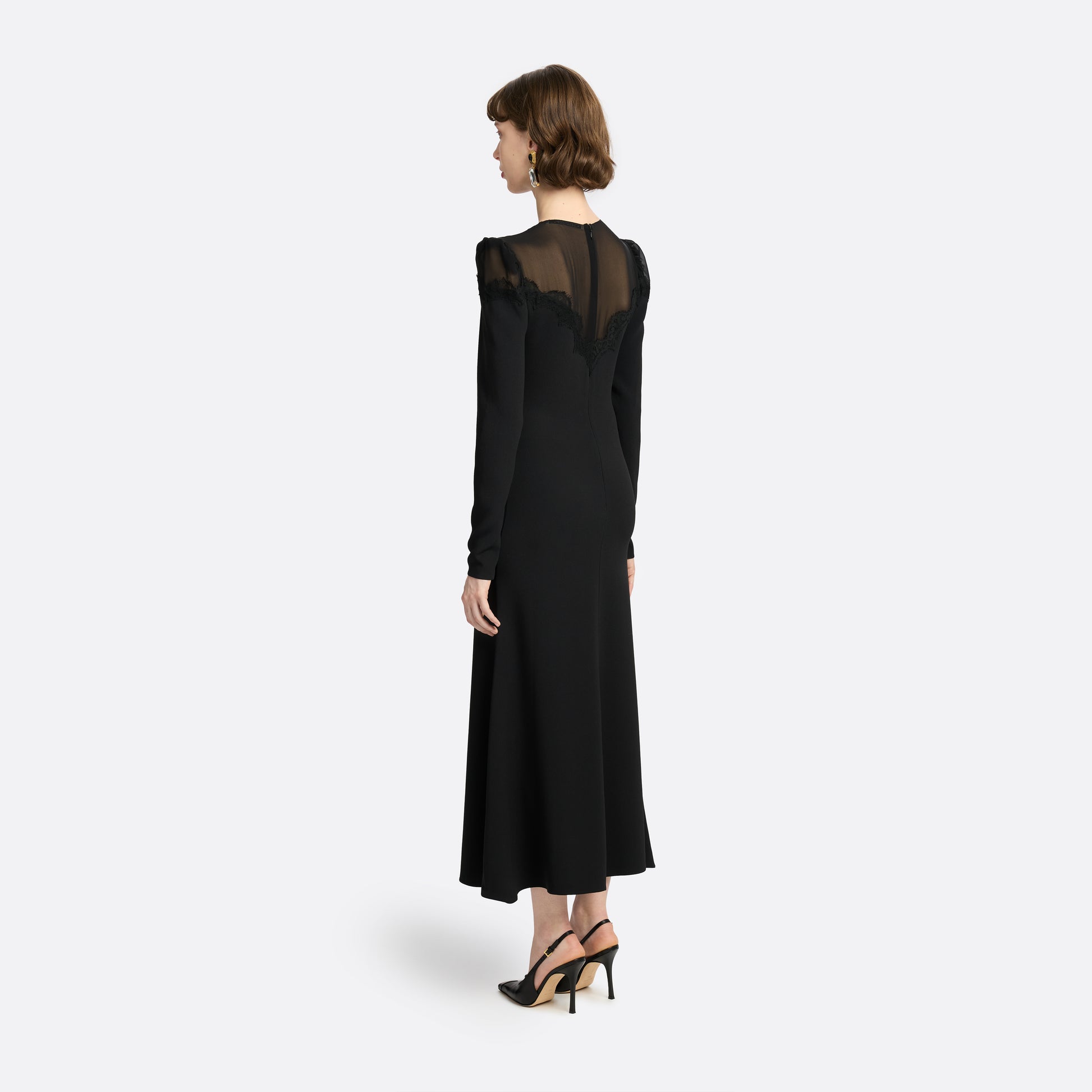 Black cady and silk georgette midi dress cut to a fitted silhouette with an A-line skirt. Finished with a sheer pleated yoke with delicate lace inlay.