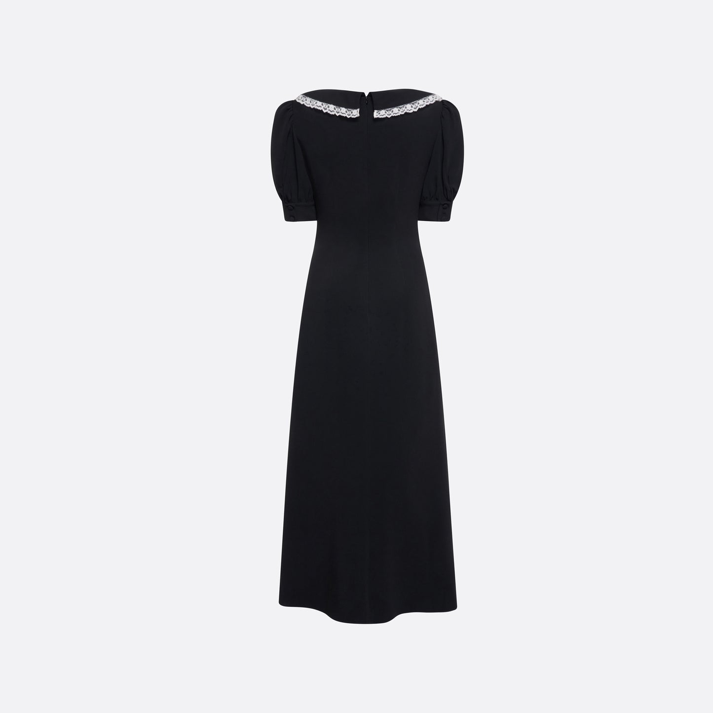 Black cady midi dress with a wrap-style silhouette and asymmetric button detailing. The wide collar is finished with a white lace trim.

Look 23 – Fall Winter 2026 Lookbook.