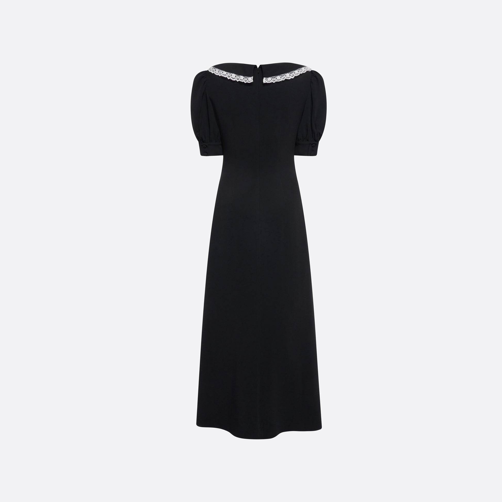 Black cady midi dress with a wrap-style silhouette and asymmetric button detailing. The wide collar is finished with a white lace trim.

Look 23 – Fall Winter 2026 Lookbook.