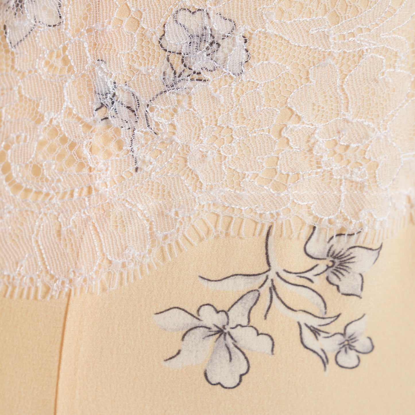 Pale yellow floral print silk crêpe de chine midi dress with long sleeves, featuring keyhole cut-out, lace inlay and bows.