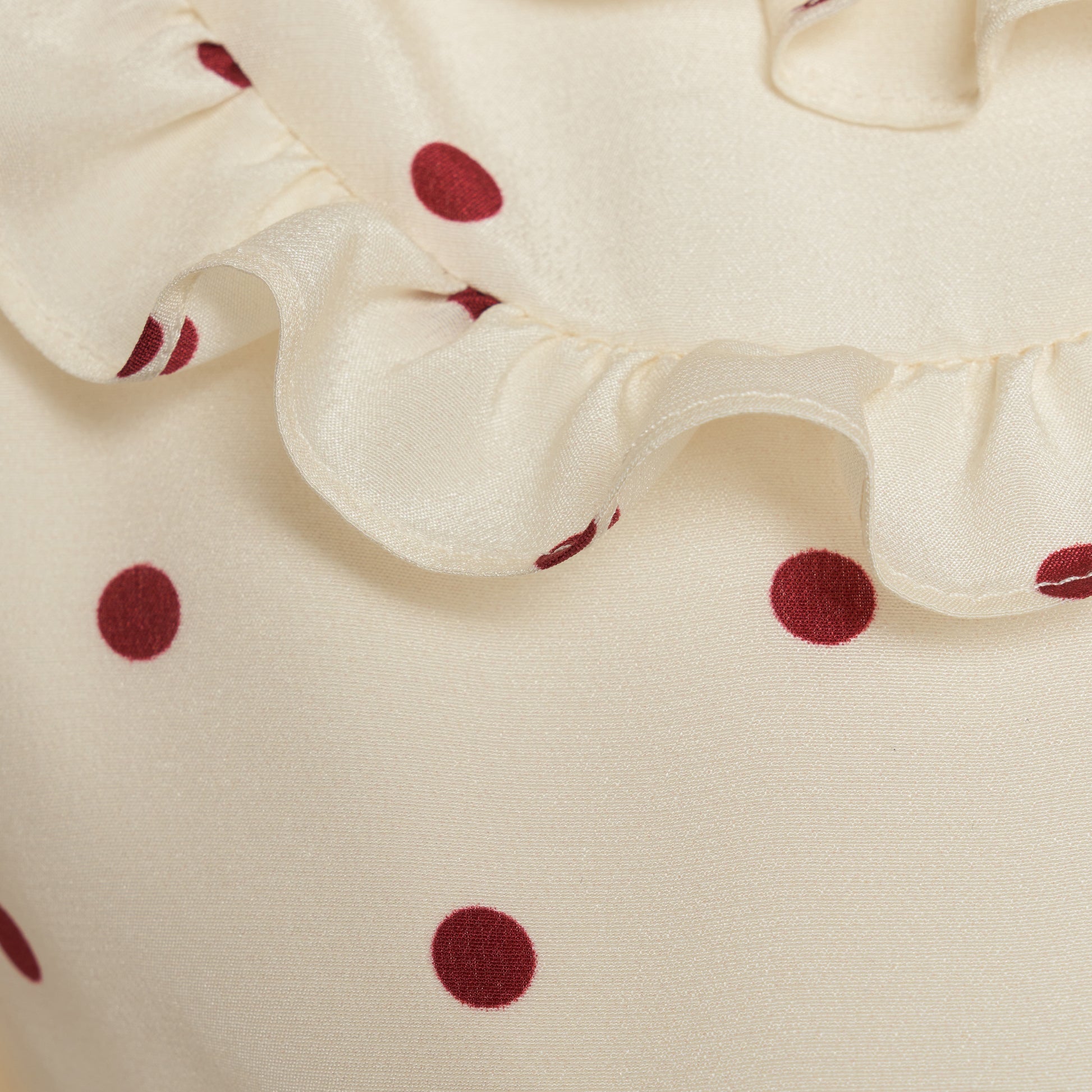 Cream and bordeaux polka-dot silk crêpe de chine midi dress with short puff sleeves and a ruffled collar finished with a tie detail.