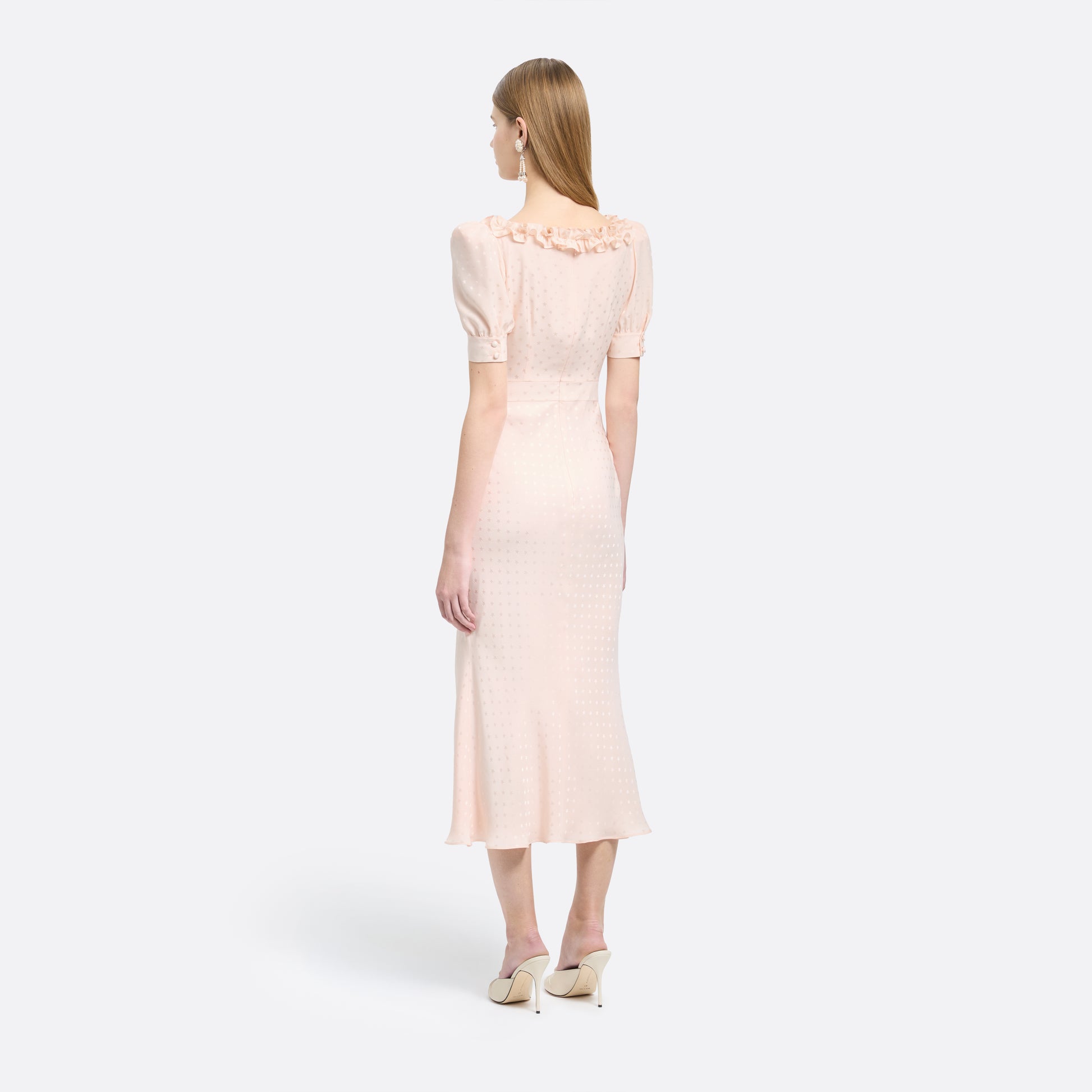 Light pink star-jacquard silk midi dress with short puff sleeves and a square neckline detailed with black bows and a ruffled trim.