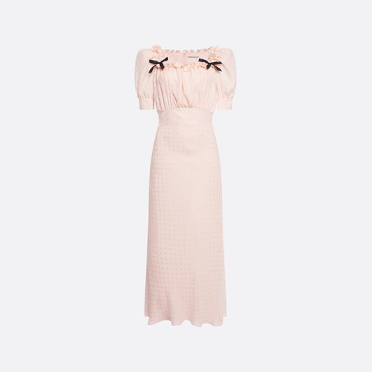 Light pink star-jacquard silk midi dress with short puff sleeves and a square neckline detailed with black bows and a ruffled trim.