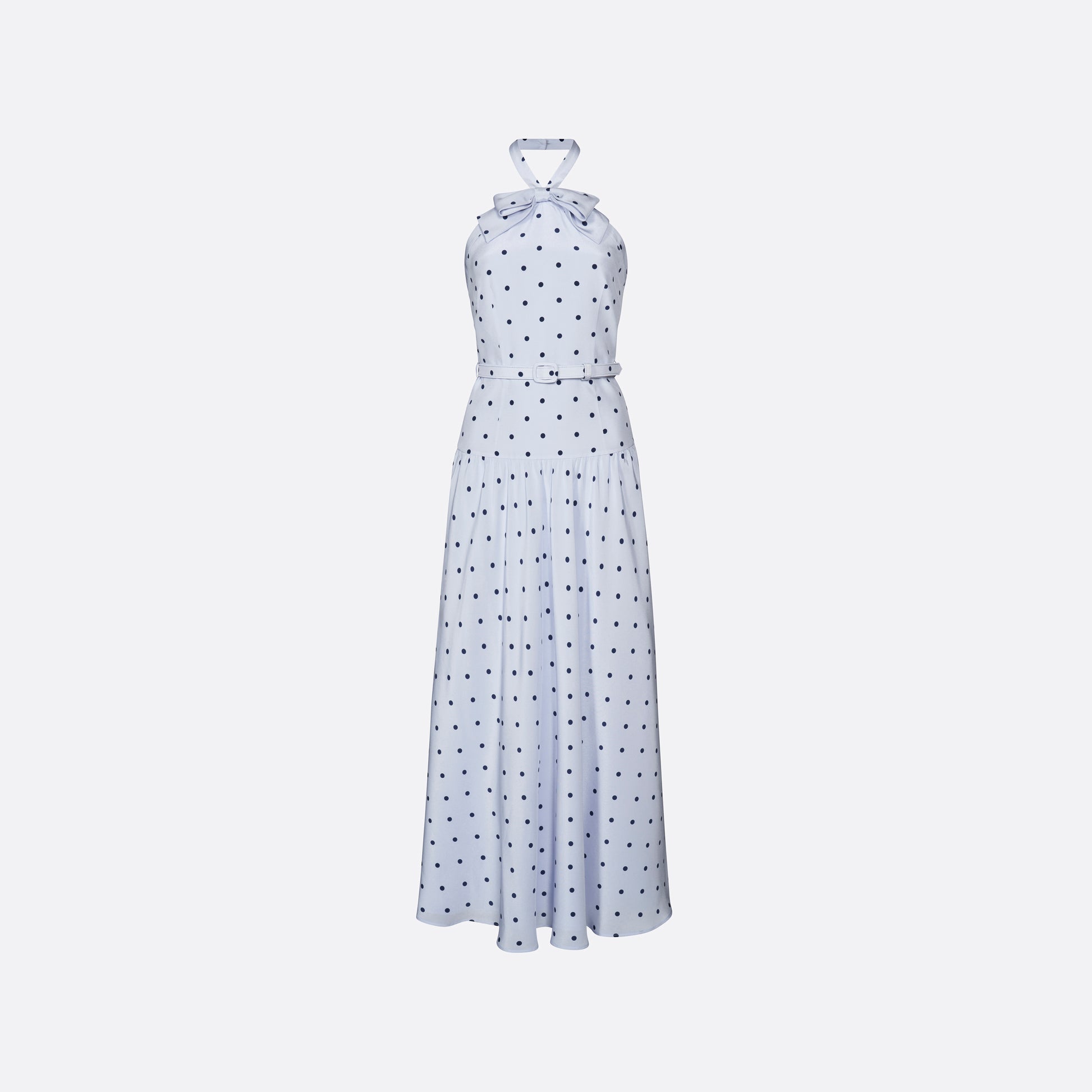Light blue polka-dot silk crêpe de chine halterneck dress with a bow detail at the neckline. Defined by a fitted waist with a slim belt, the silhouette is finished with a flared skirt.