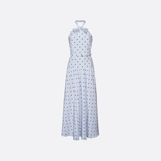 Light blue polka-dot silk crêpe de chine halterneck dress with a bow detail at the neckline. Defined by a fitted waist with a slim belt, the silhouette is finished with a flared skirt.
