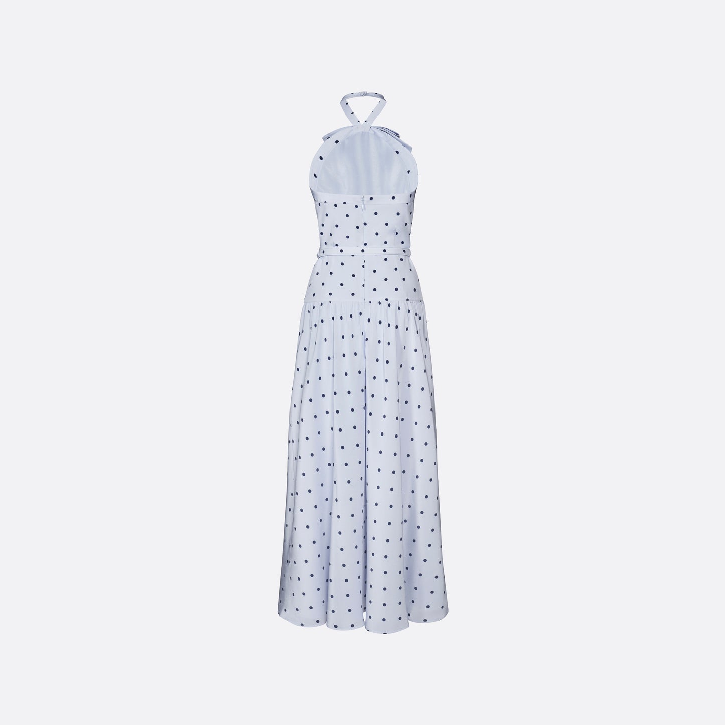 Light blue polka-dot silk crêpe de chine halterneck dress with a bow detail at the neckline. Defined by a fitted waist with a slim belt, the silhouette is finished with a flared skirt.