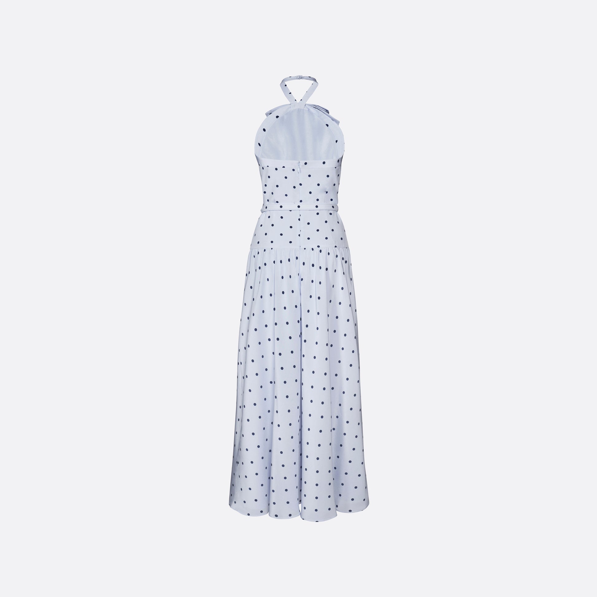 Light blue polka-dot silk crêpe de chine halterneck dress with a bow detail at the neckline. Defined by a fitted waist with a slim belt, the silhouette is finished with a flared skirt.