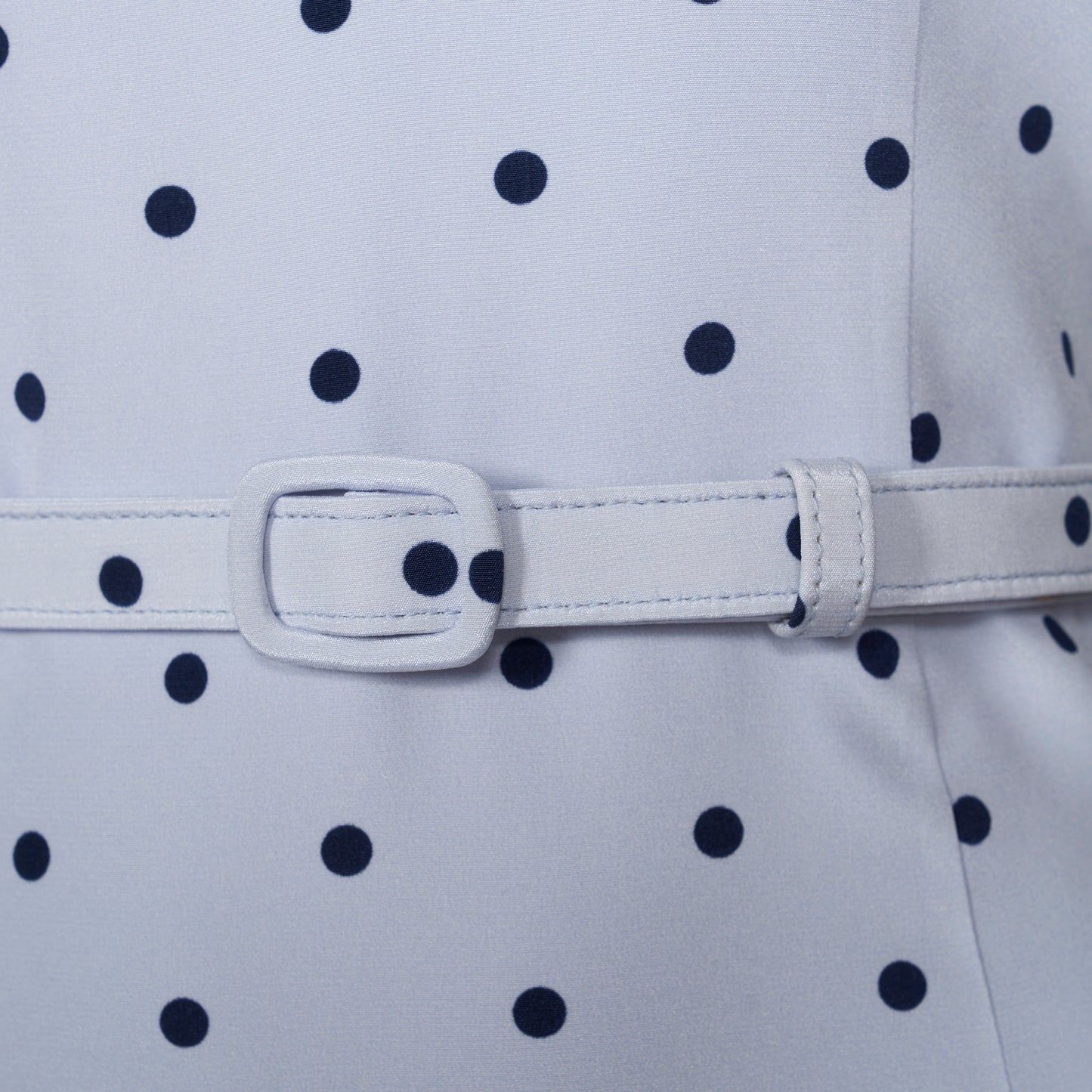 Light blue polka-dot silk crêpe de chine halterneck dress with a bow detail at the neckline. Defined by a fitted waist with a slim belt, the silhouette is finished with a flared skirt.