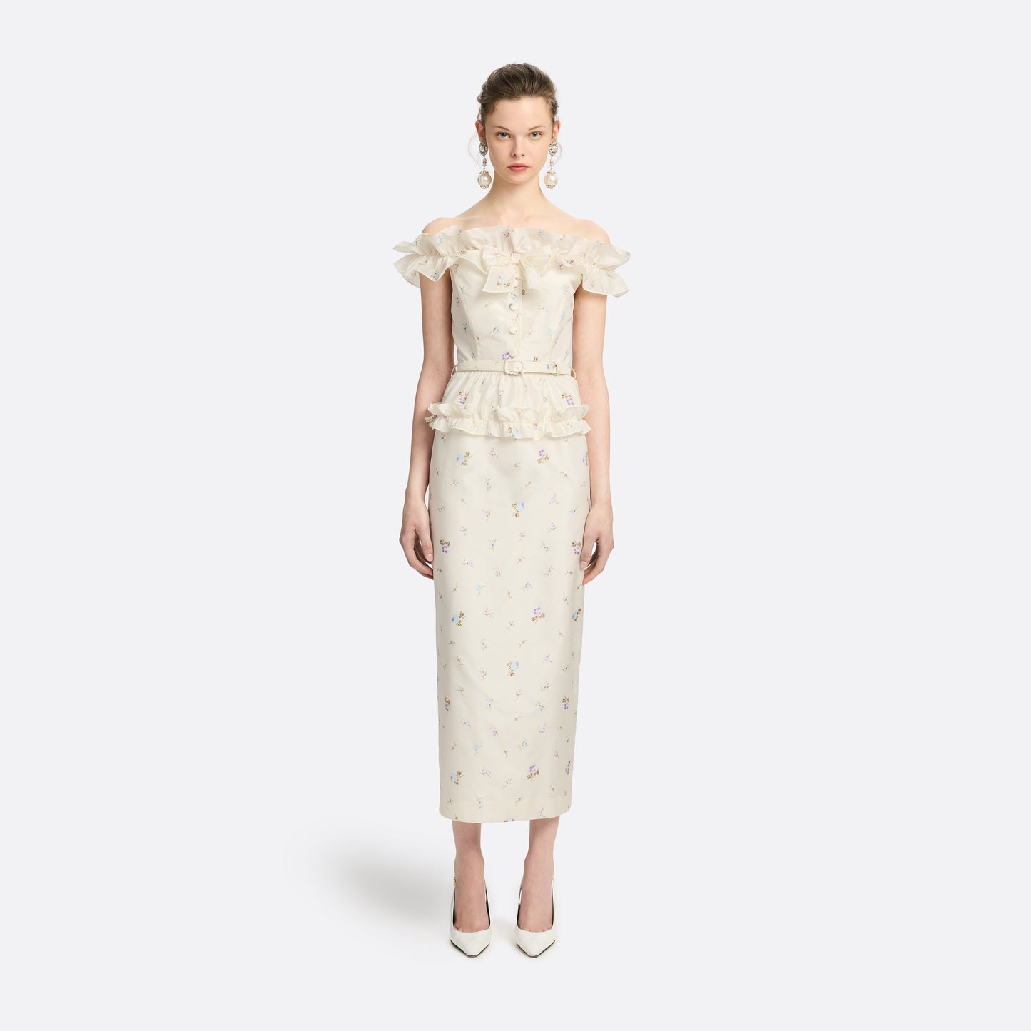 Floral-print white silk taffeta off-shoulder midi dress cut to a fitted silhouette and detailed with a ruffled neckline and bow. Finished with a peplum frill and a slim belt.

Look 11 – Fall Winter 2026 Lookbook.