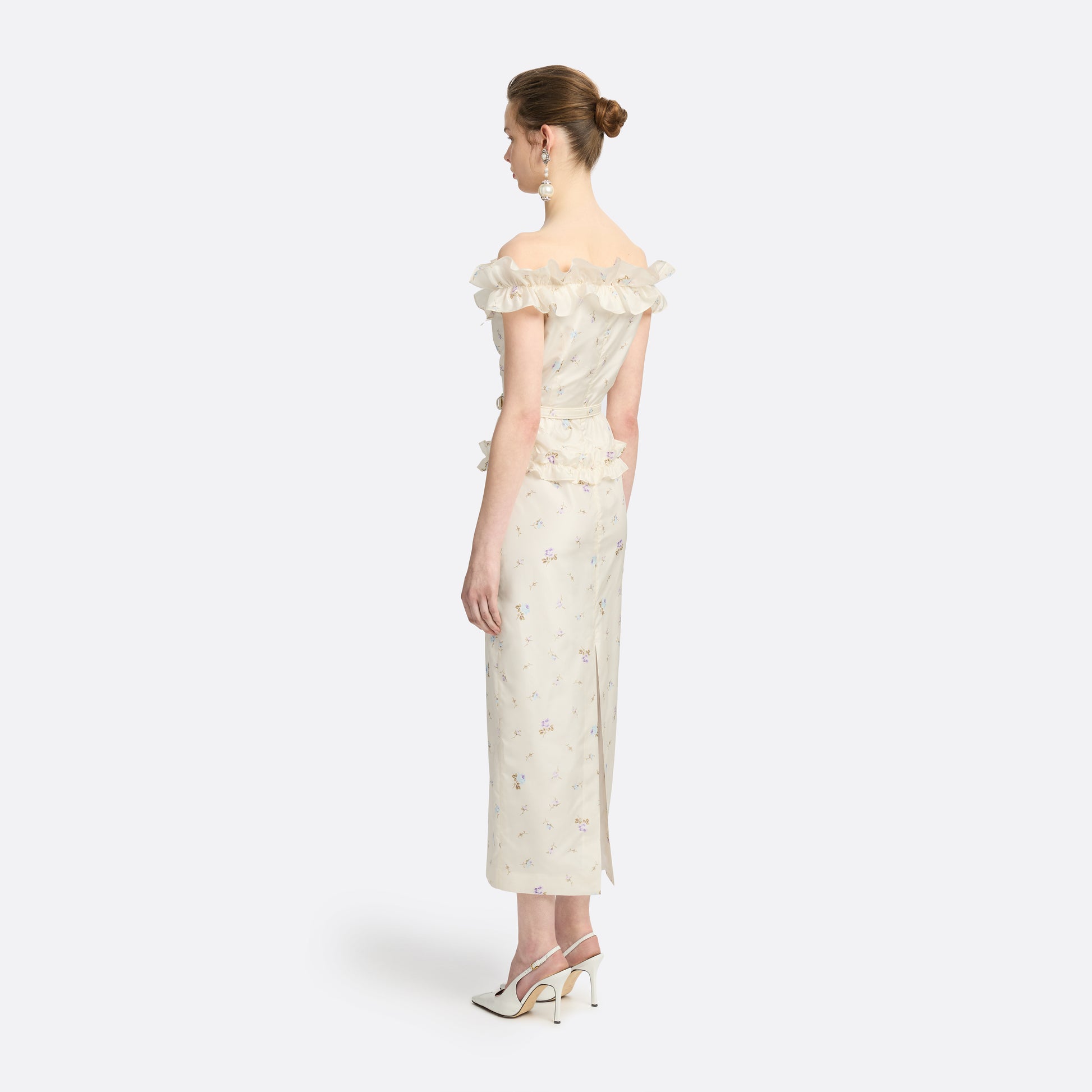 Floral-print white silk taffeta off-shoulder midi dress cut to a fitted silhouette and detailed with a ruffled neckline and bow. Finished with a peplum frill and a slim belt.

Look 11 – Fall Winter 2026 Lookbook.