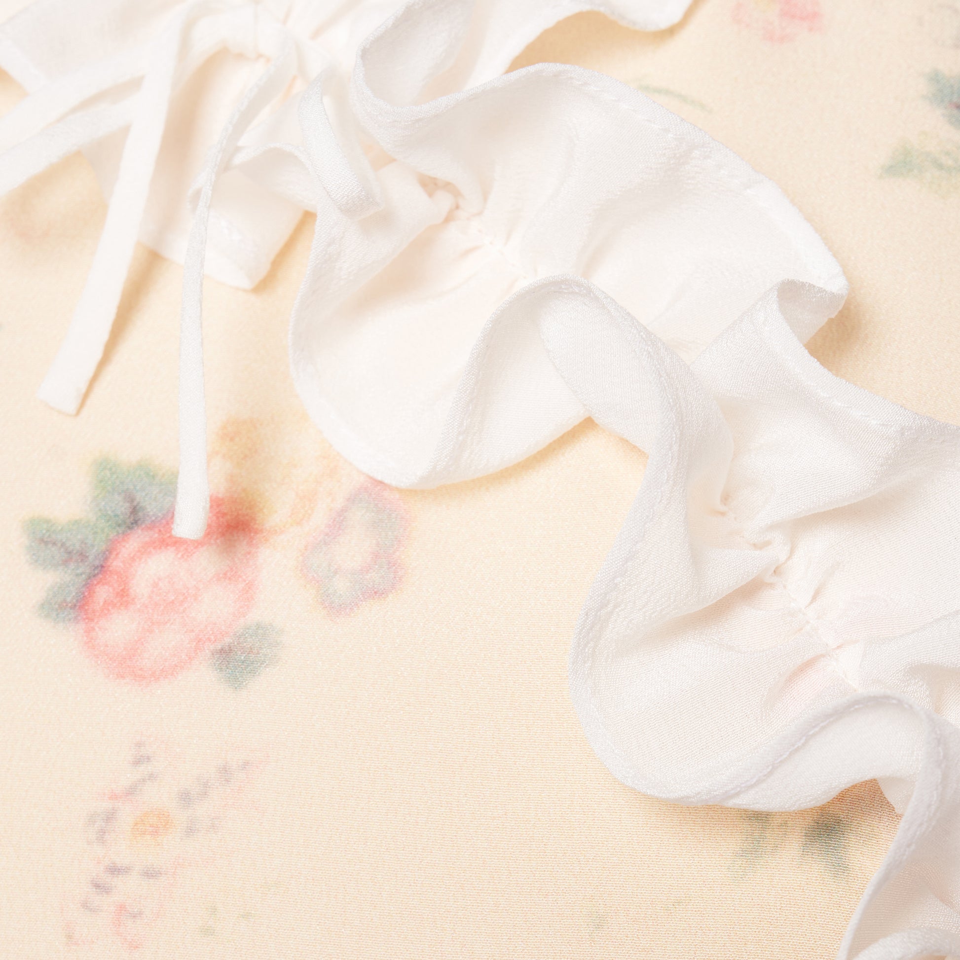 Cream floral-print silk crêpe de chine midi dress with short sleeves detailed with a ruffled trim and an asymmetric ruffle detail finished with bows.