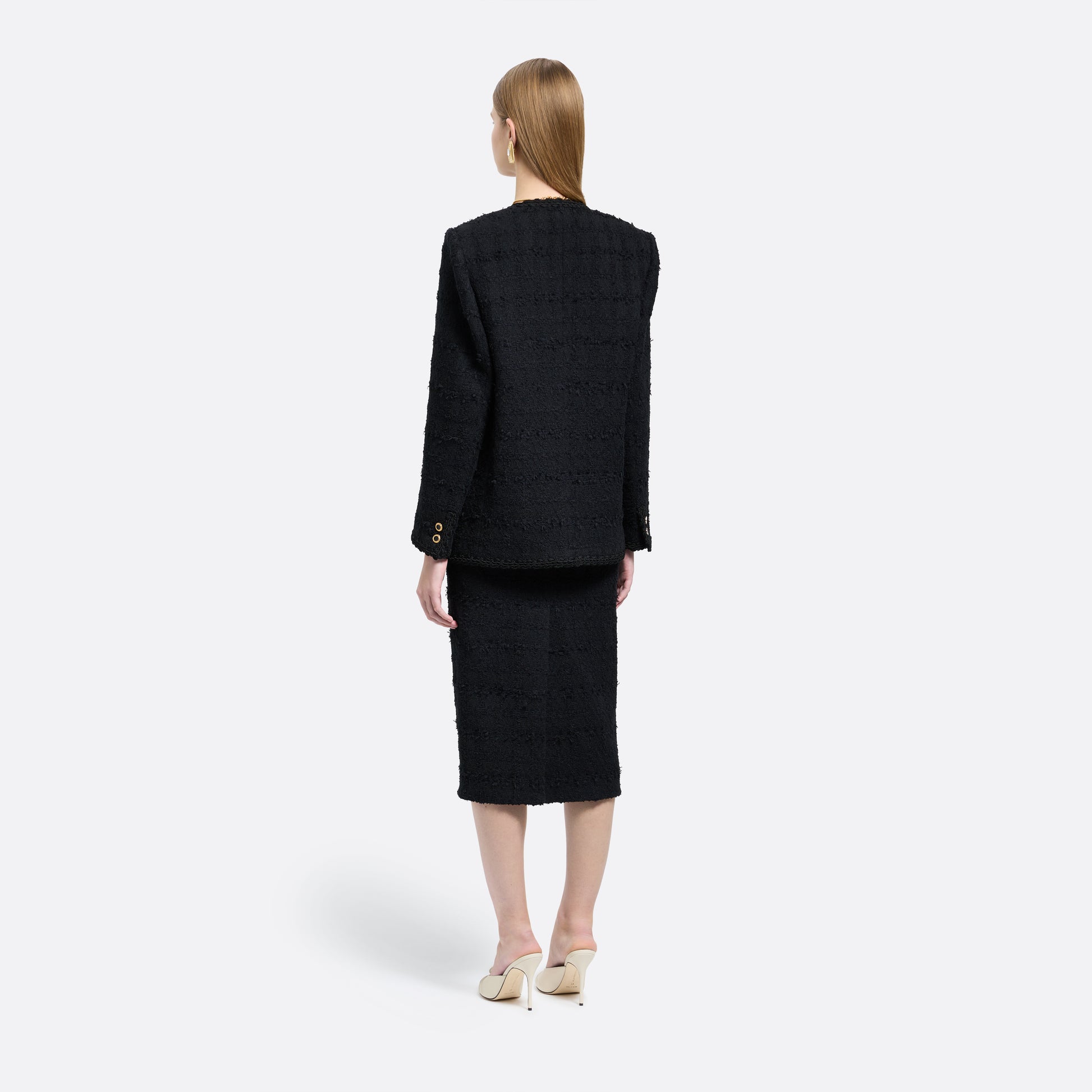 Black check tweed bouclé double-breasted jacket cut to a slightly boxy silhouette with long sleeves finished with gold-tone buttons.

Look 5 – Fall Winter 2026 Lookbook.