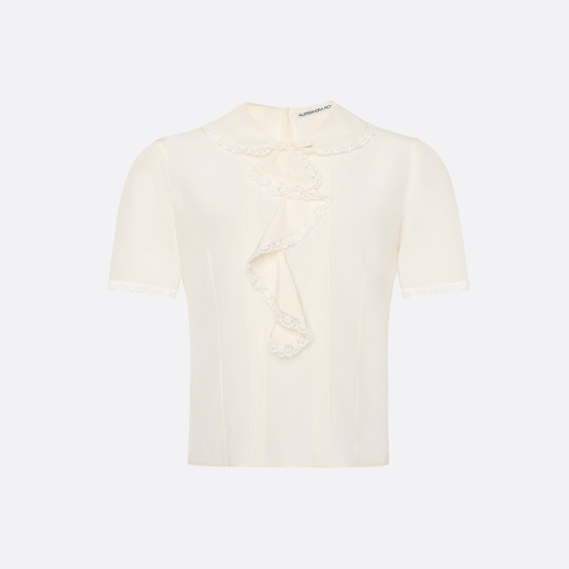 Cream silk crêpe de chine blouse with small collar, jabot and short sleeves all trimmed in lace and a back button closure.